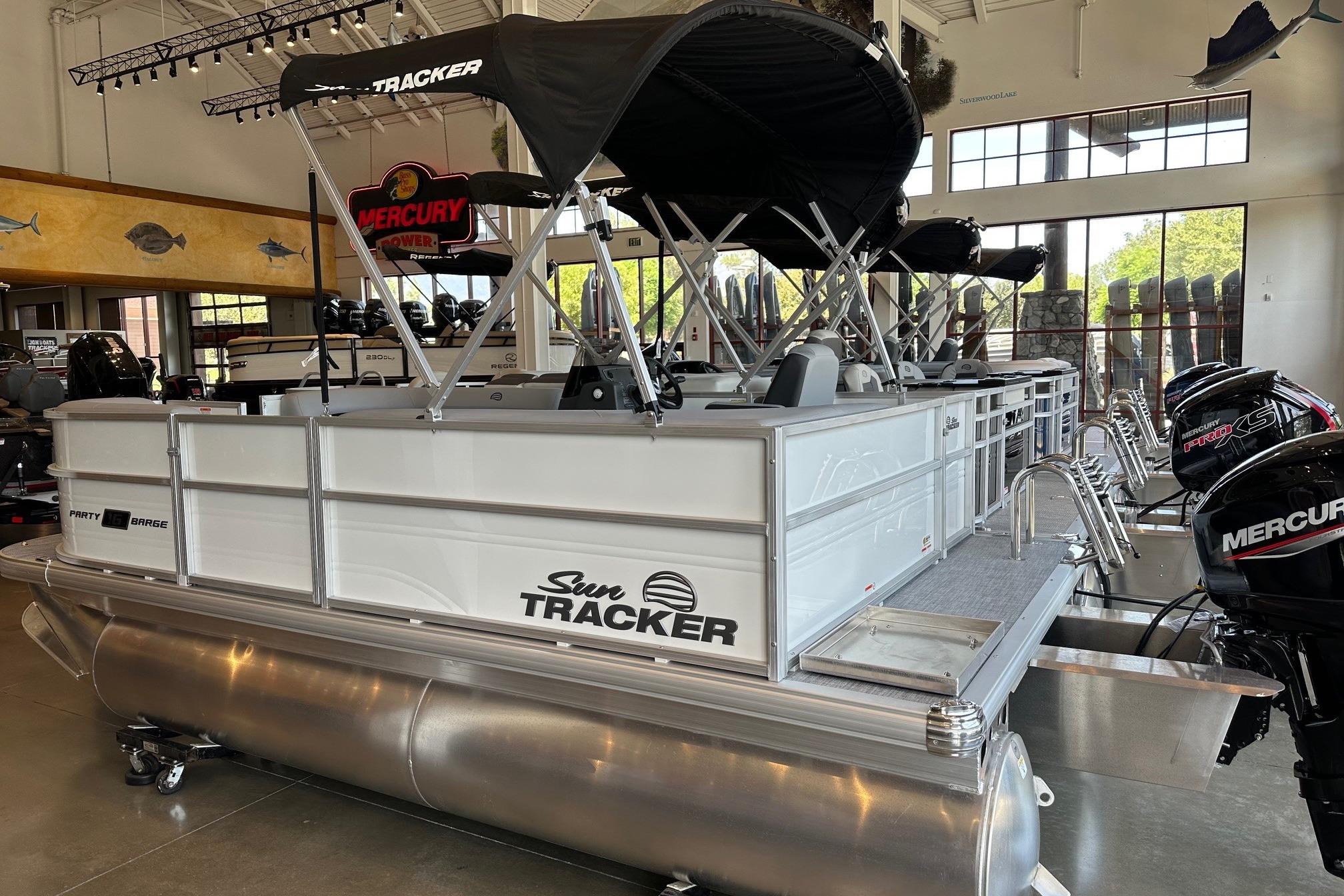 2026 Sun Tracker Party Barge 16 DLX pontoon boat displayed in showroom.