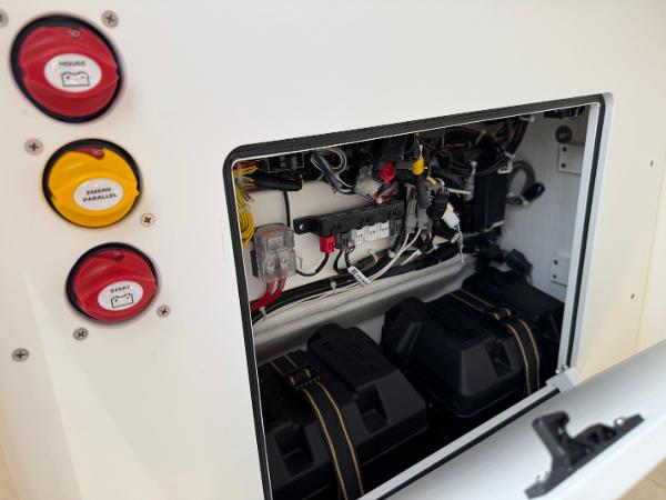 2025 NorthCoast 230 Center Console electrical panel with battery compartments and wiring.