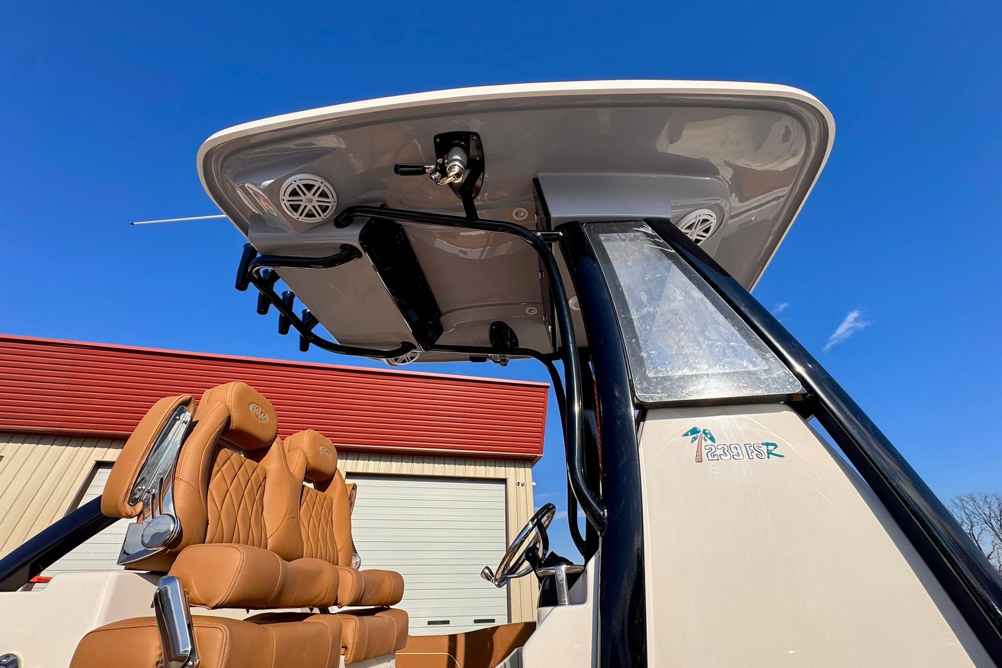 2026 Key West 239 FSR boat with tan seats and T-top against blue sky.
