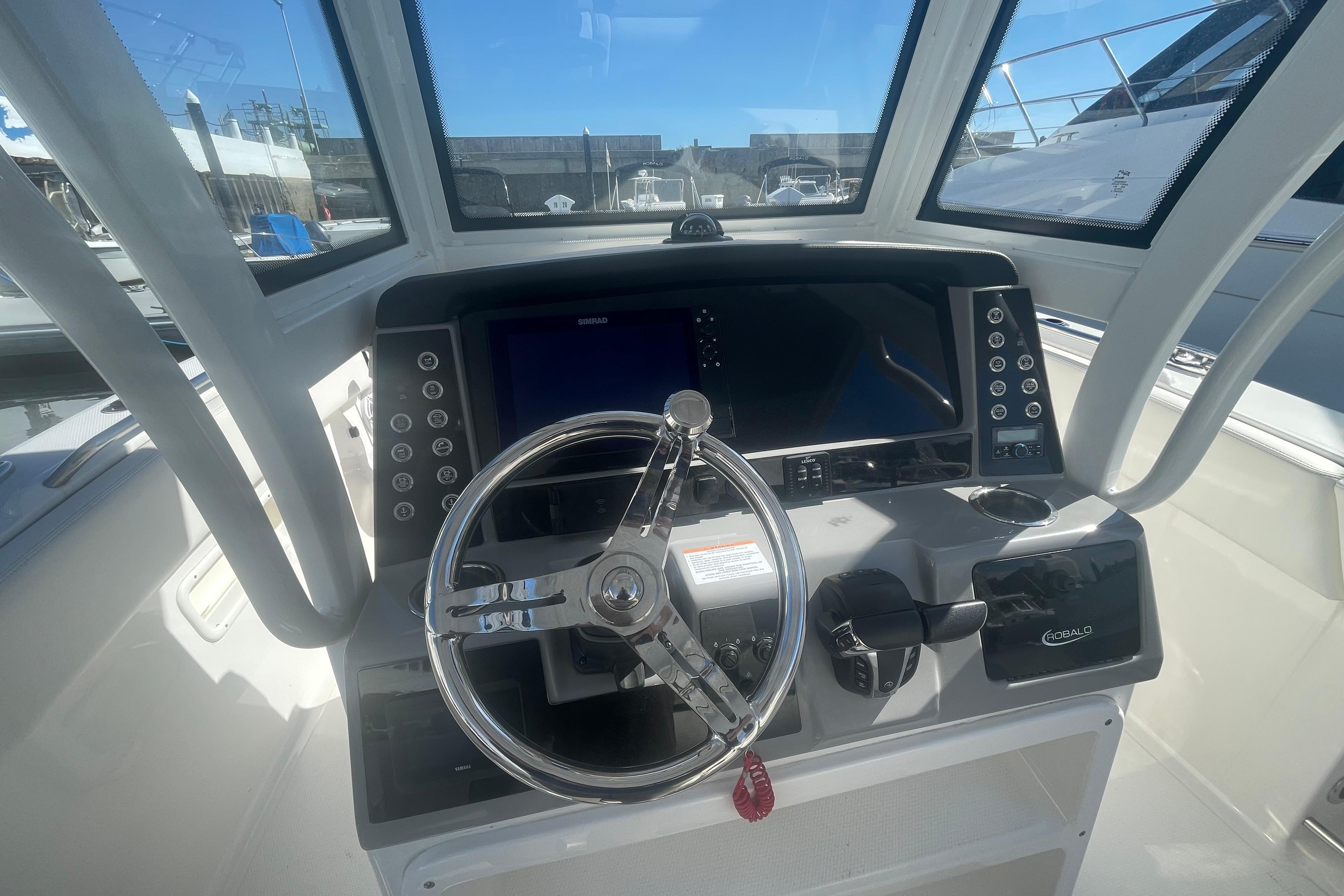 2023 Robalo R270 Center Console helm with steering wheel and control panel.