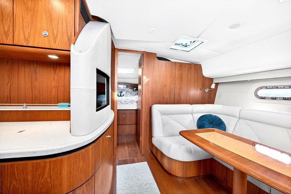 Luxurious 2006 Tiara Yachts 4300 Sovran interior with elegant wood finishes and plush seating.