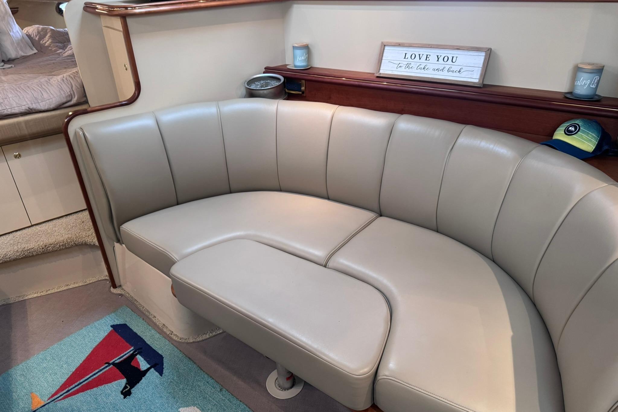 Interior of 2002 Cruisers Yachts 3275 Express with beige leather seating and decorative accents.