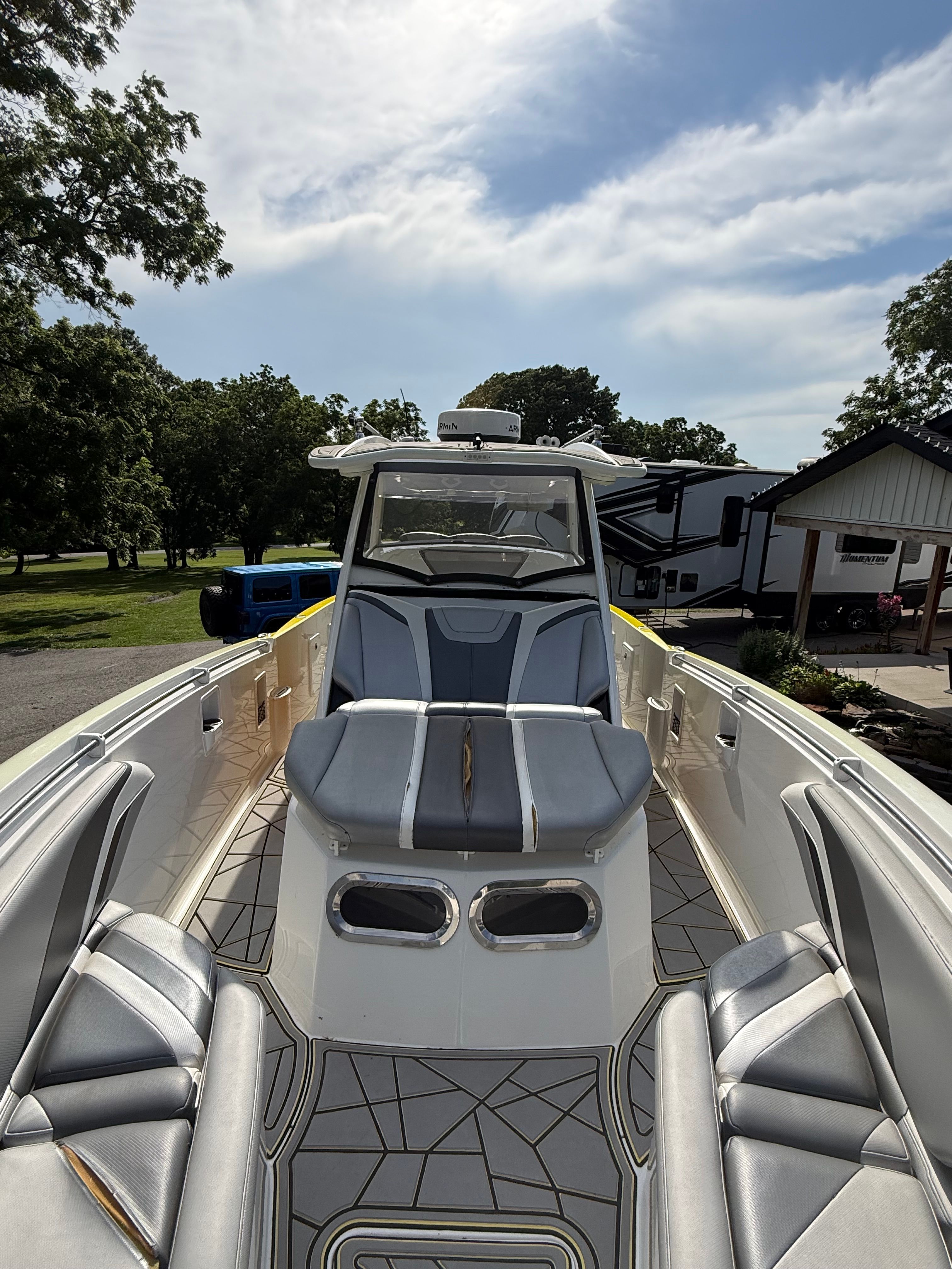 A 2014 Sunsation 34 CCX with sleek design, gray upholstery, and a modern helm station.