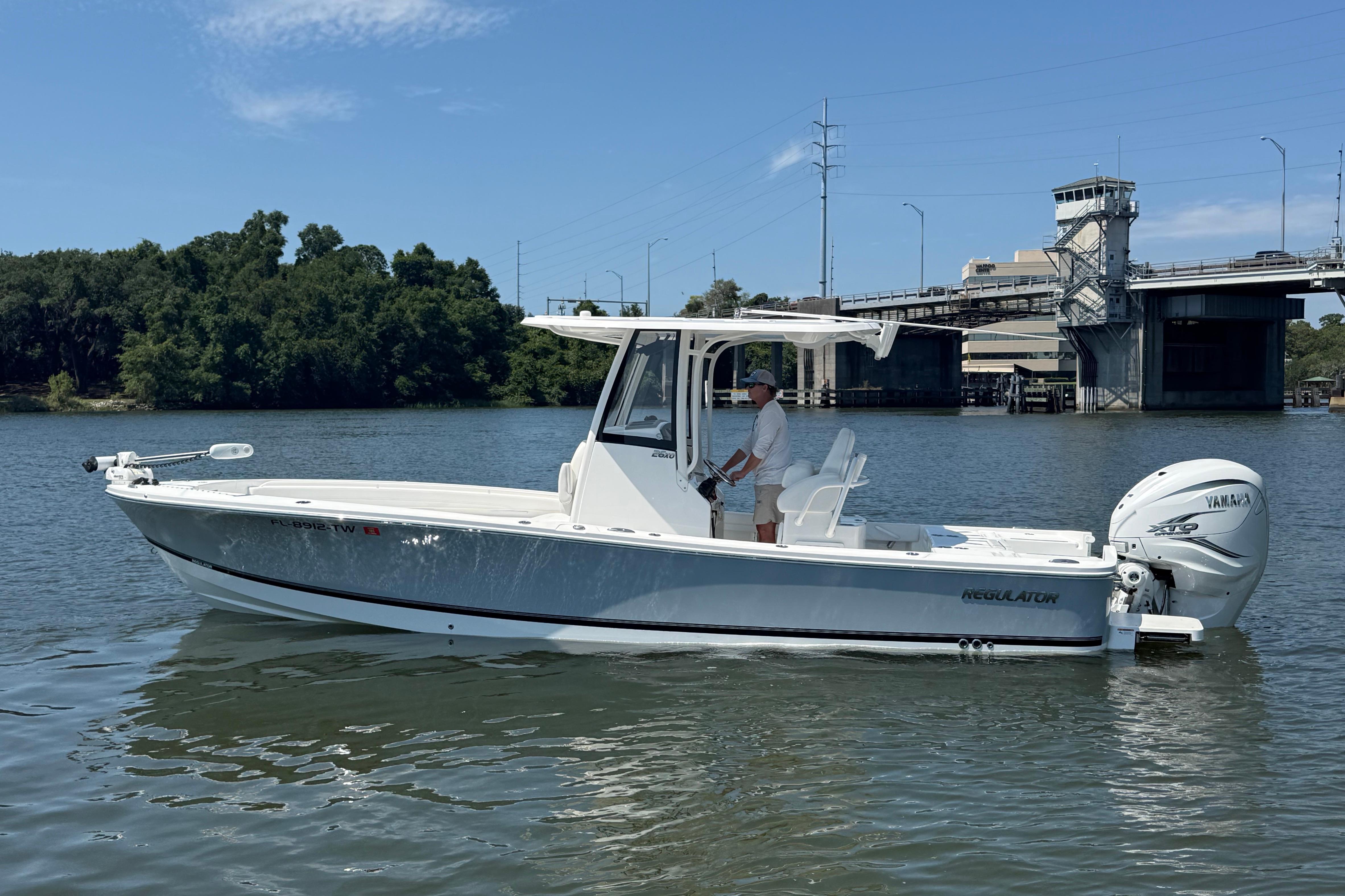 2023 Regulator 26XO boat on water near a bridge, featuring Yamaha engine.
