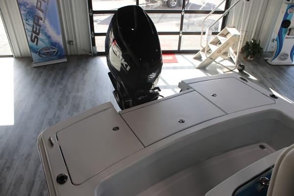 2025 East Cape 25 Open boat with outboard motor in showroom.