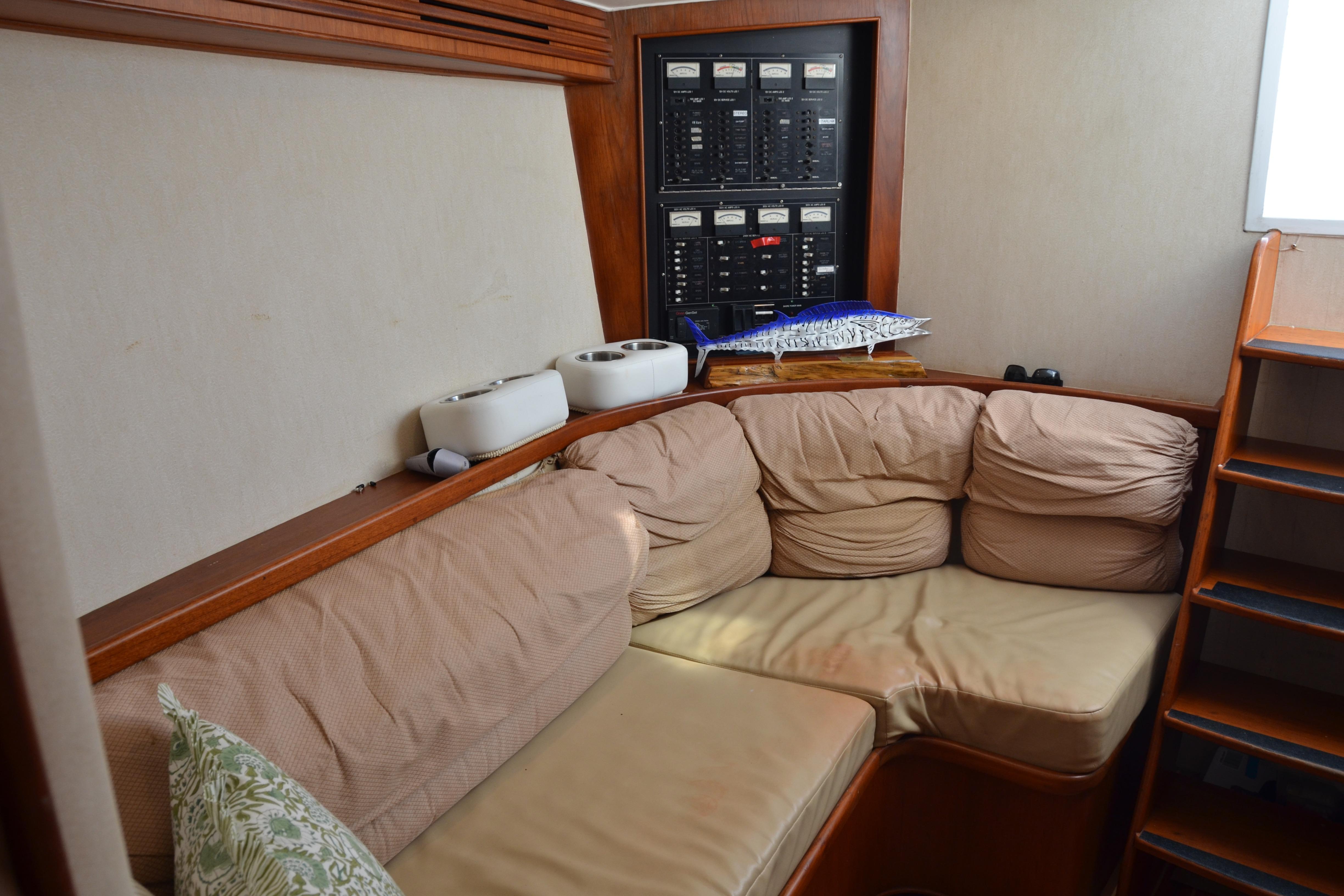 Cozy interior of 2006 Custom Carolina Heritage Express boat with cushioned seating and control panel.