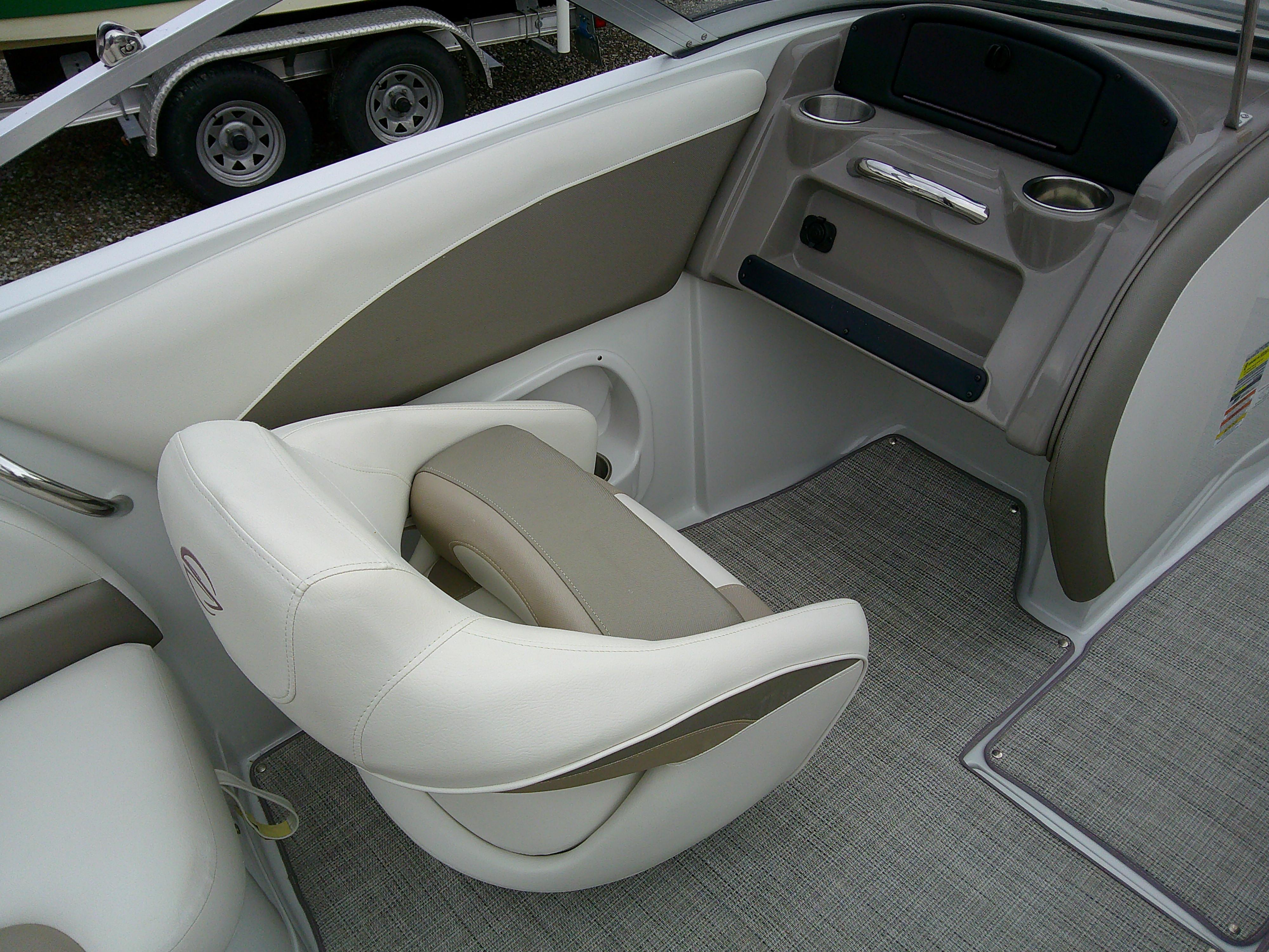 2019 Crownline 19 XS boat interior with beige and white seating, cup holders, and carpeted flooring.
