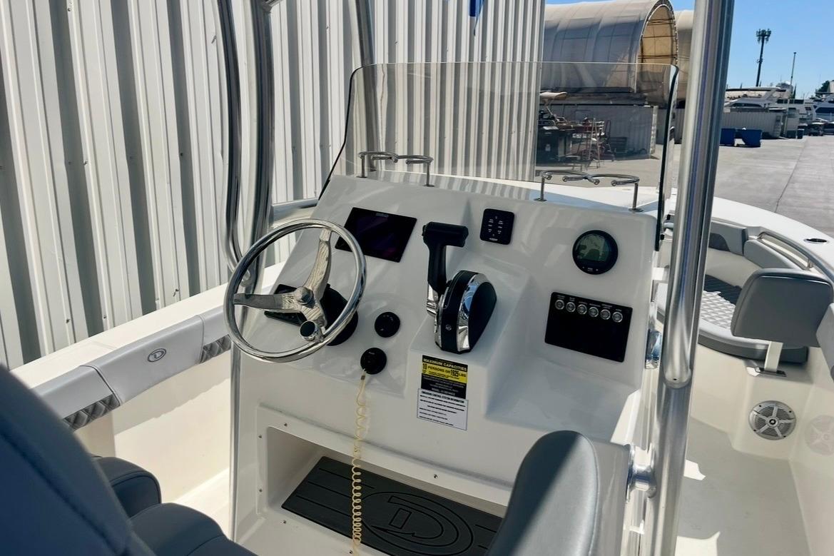 2025 Defiance Catalina 240 boat cockpit with steering wheel and control panel.