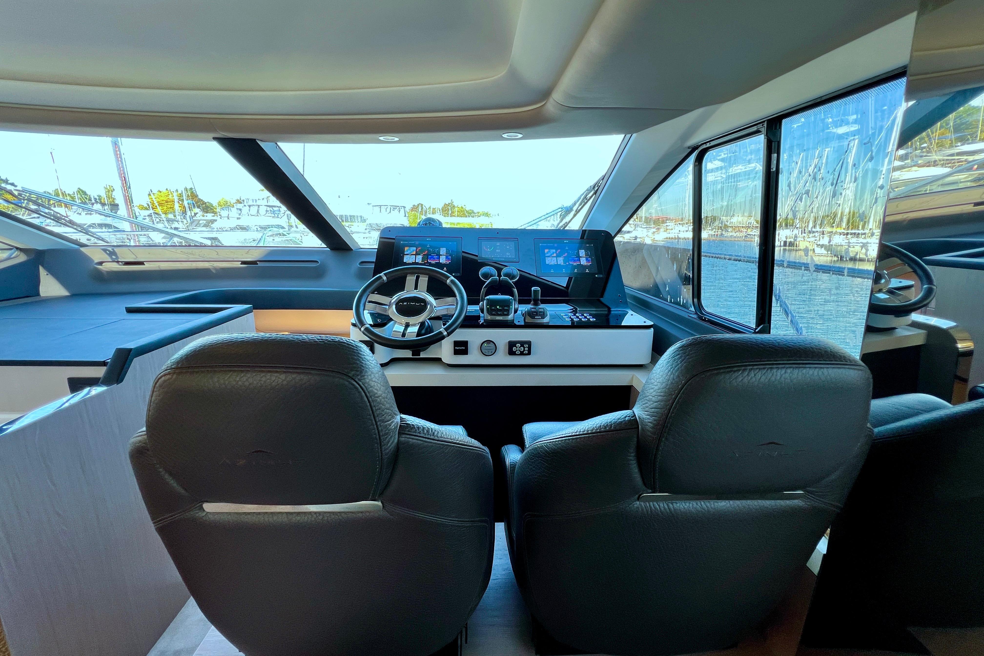 2024 Azimut Fly 60 yacht cockpit with modern steering and navigation controls.