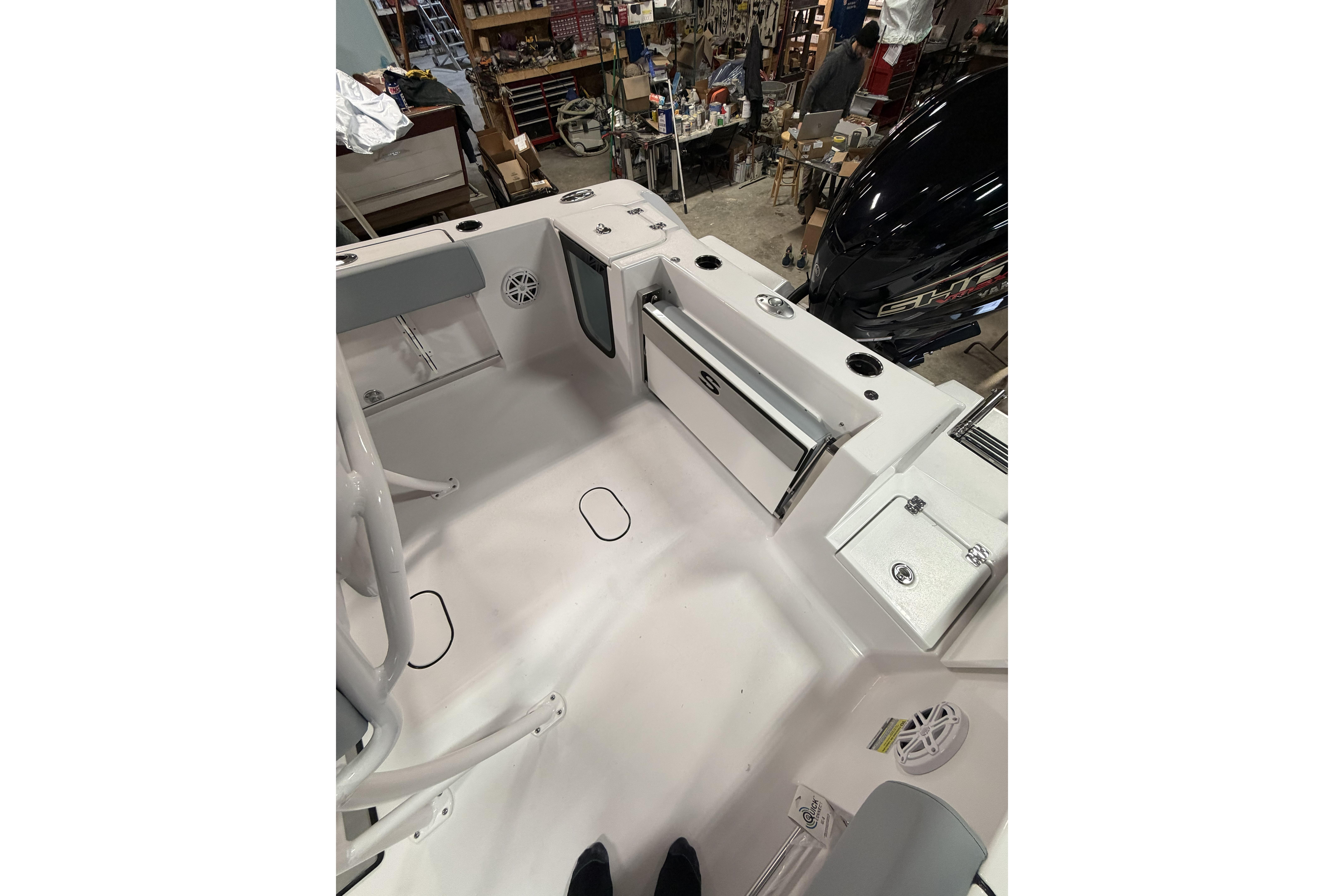 2026 Sportsman Open 232 Center Console boat interior with storage compartments and seating.
