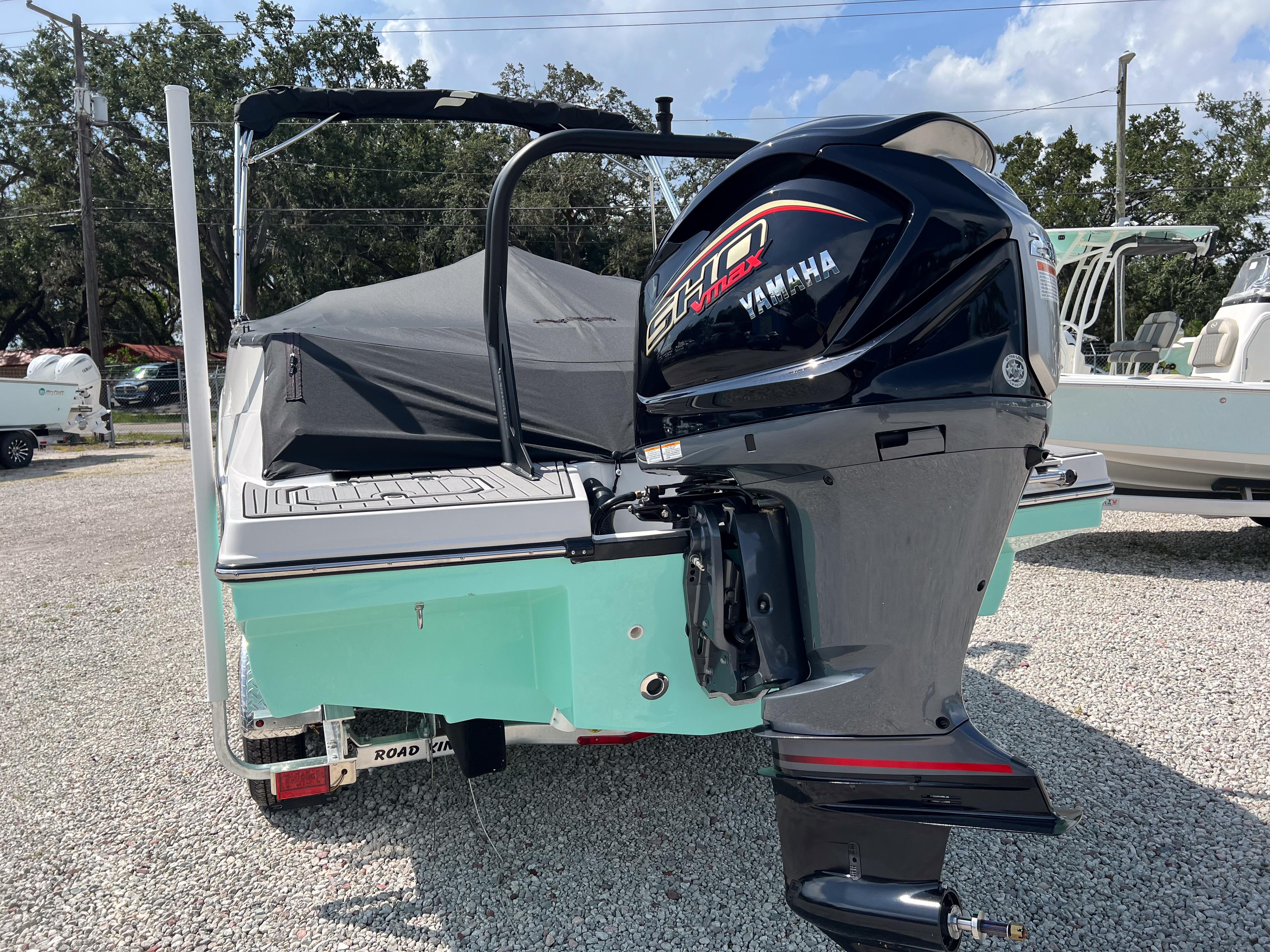 2026 Starcraft SVX 231 OB boat with Yamaha outboard motor, parked on gravel.