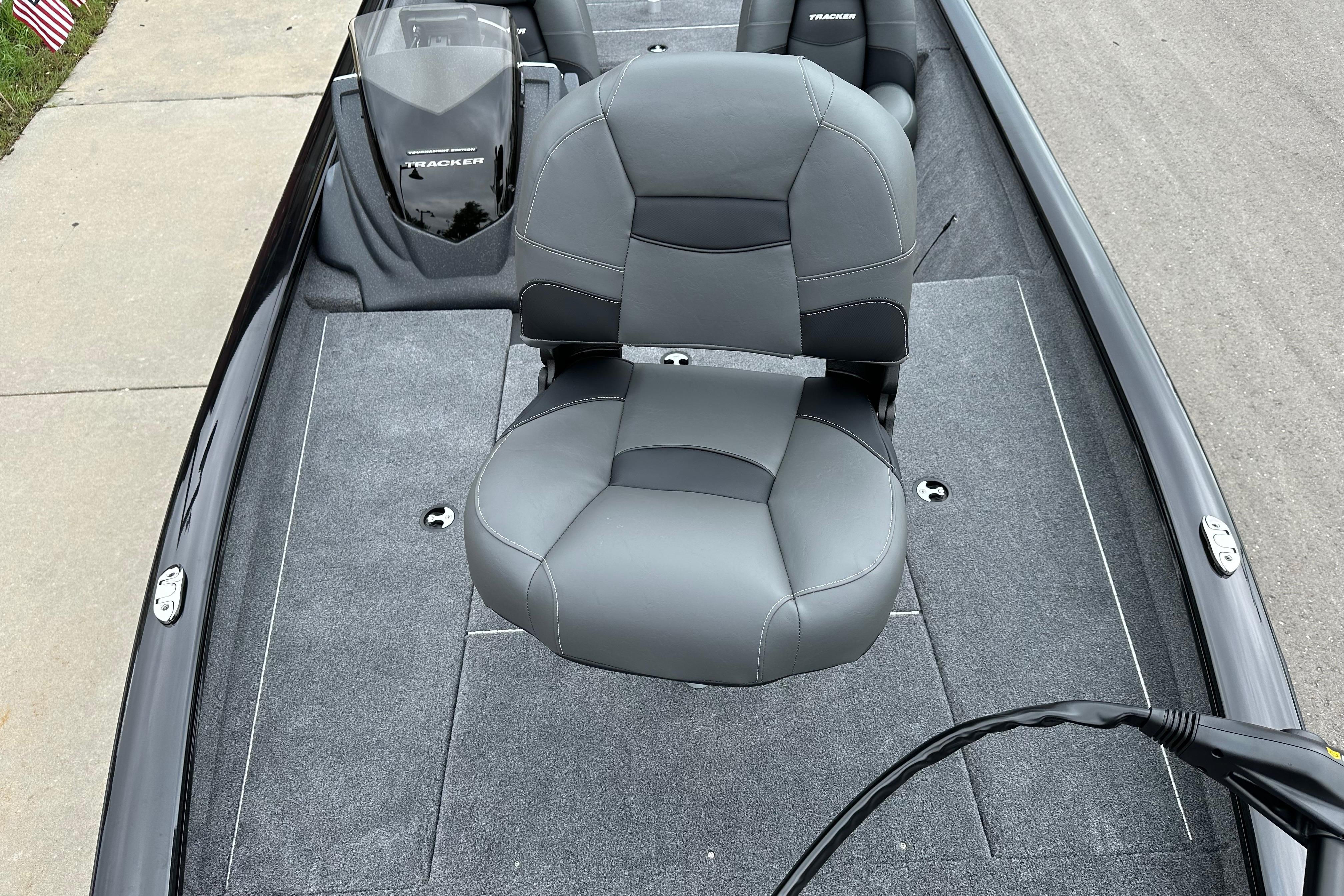 2026 Tracker Pro Team 190 boat interior with gray seating and carpeted deck.