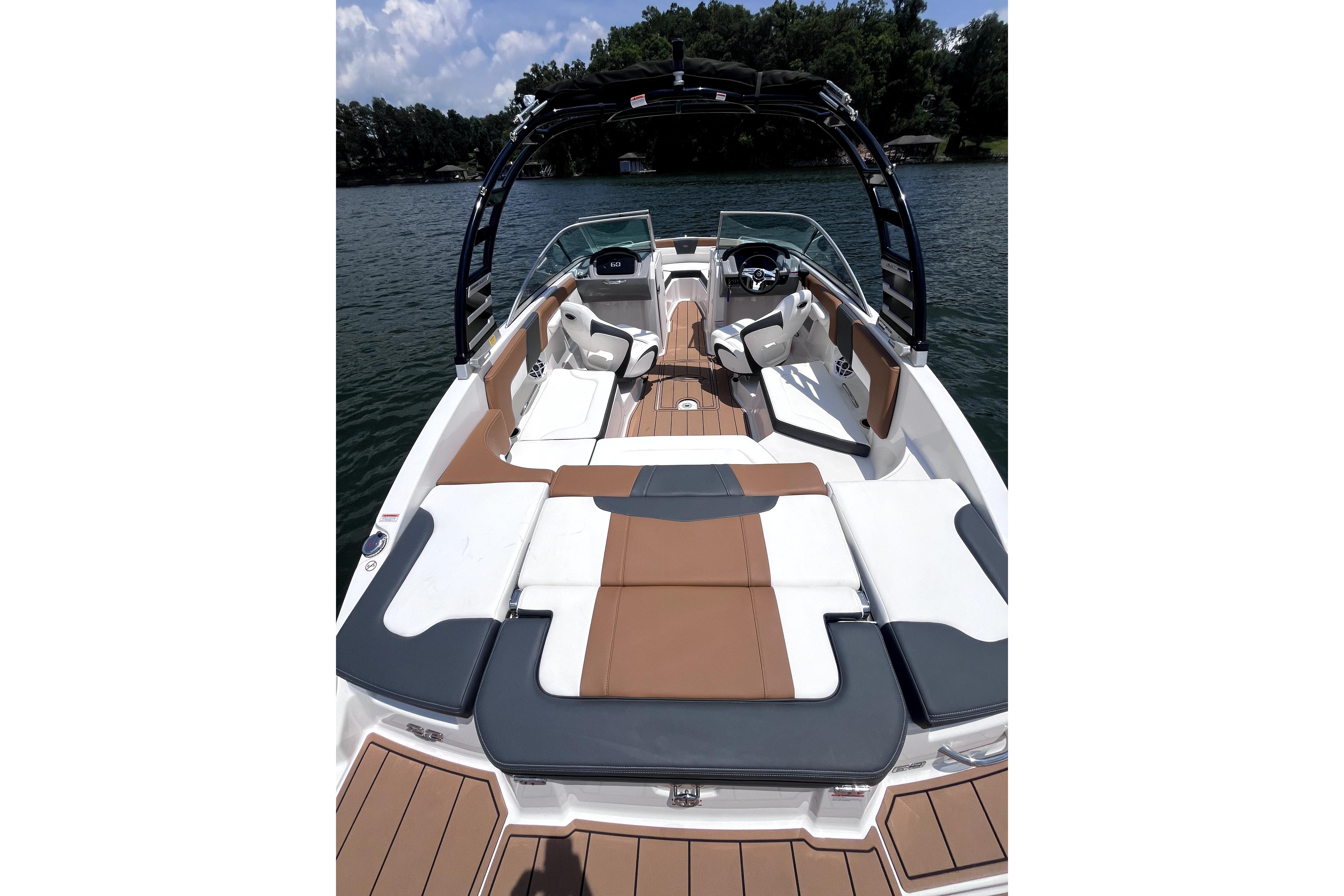 2025 Chaparral 230 SSi boat with sleek interior design on a serene lake.