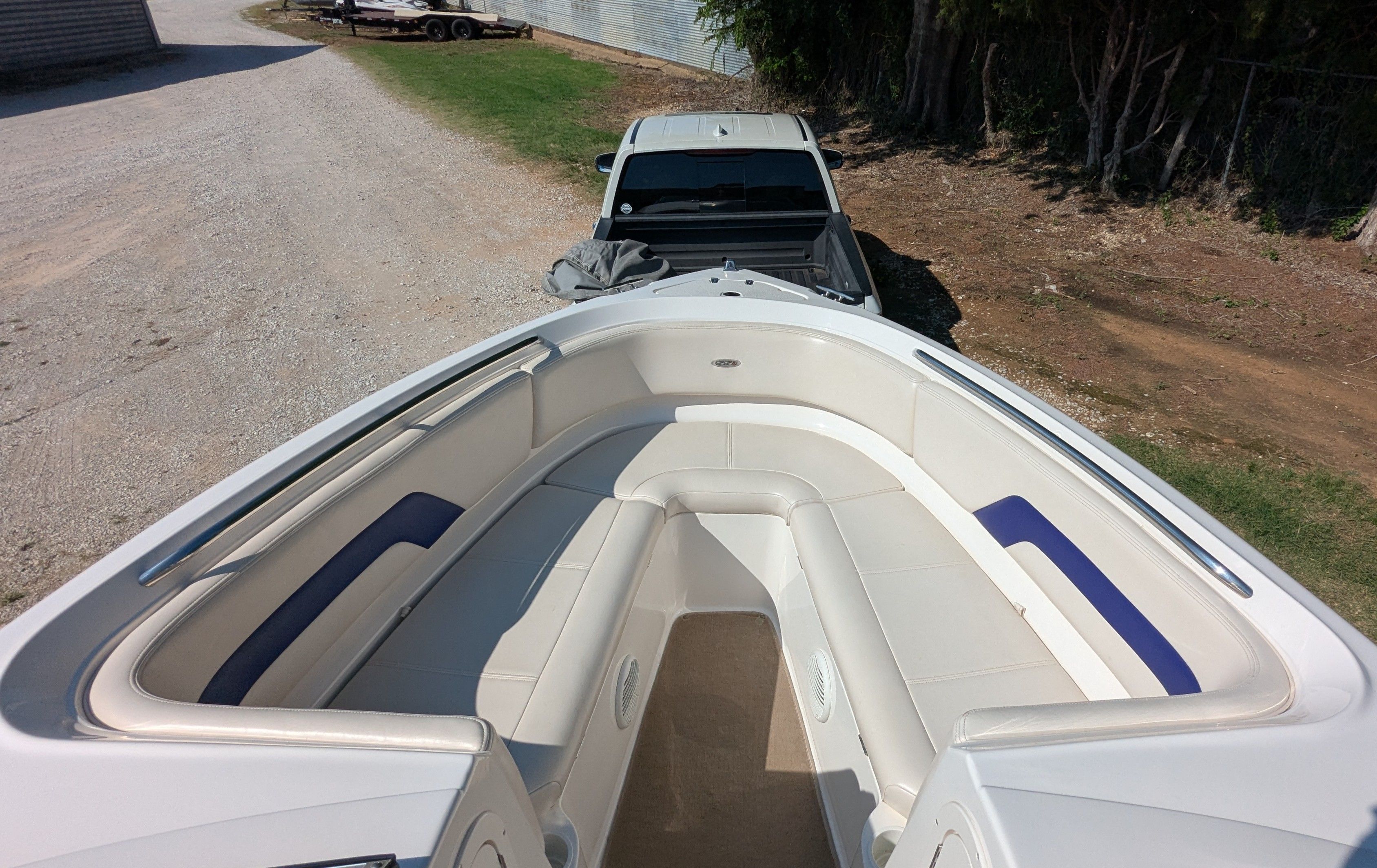 The image shows the bow of a Chaparral 240 SSi boat with white and blue seating.