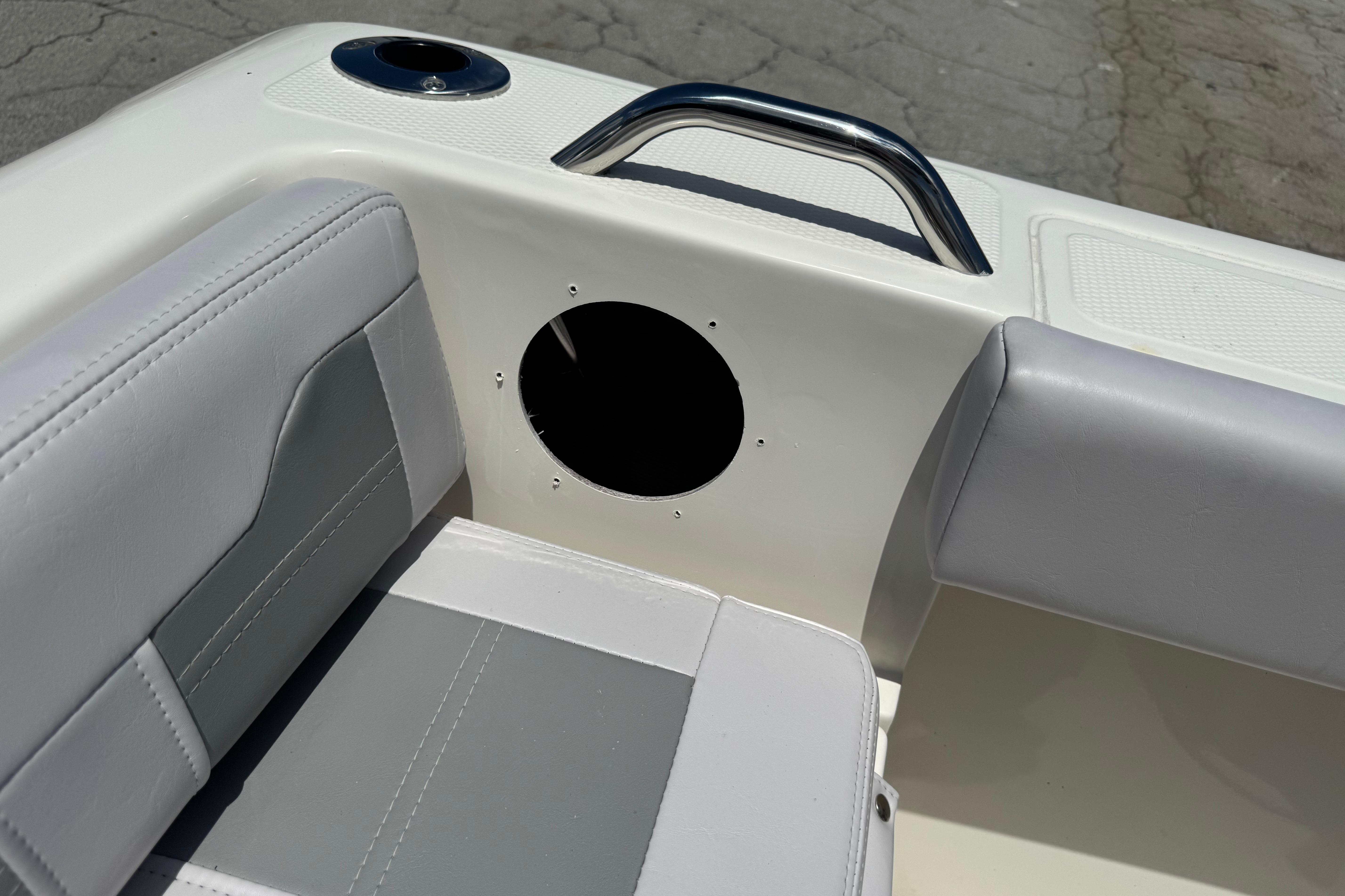 2026 Mako 214 Center Console boat interior with seating and cup holder.