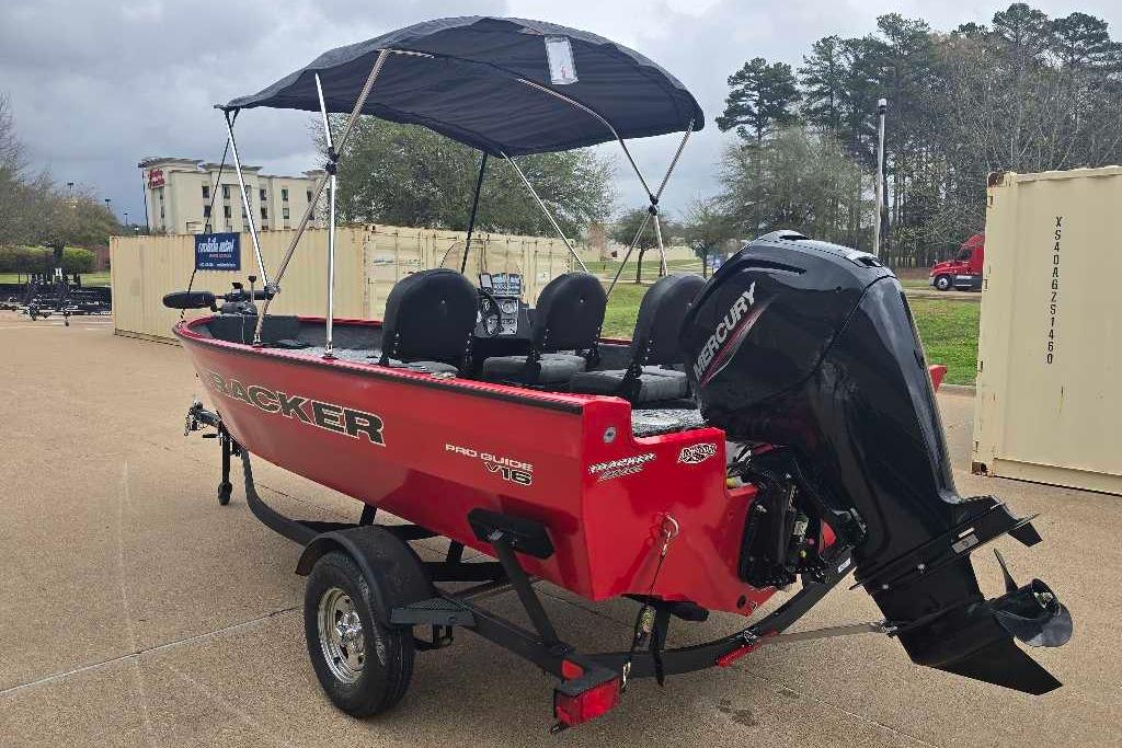 2026 Tracker Pro Guide V-16 SC boat with Mercury engine, parked outdoors.