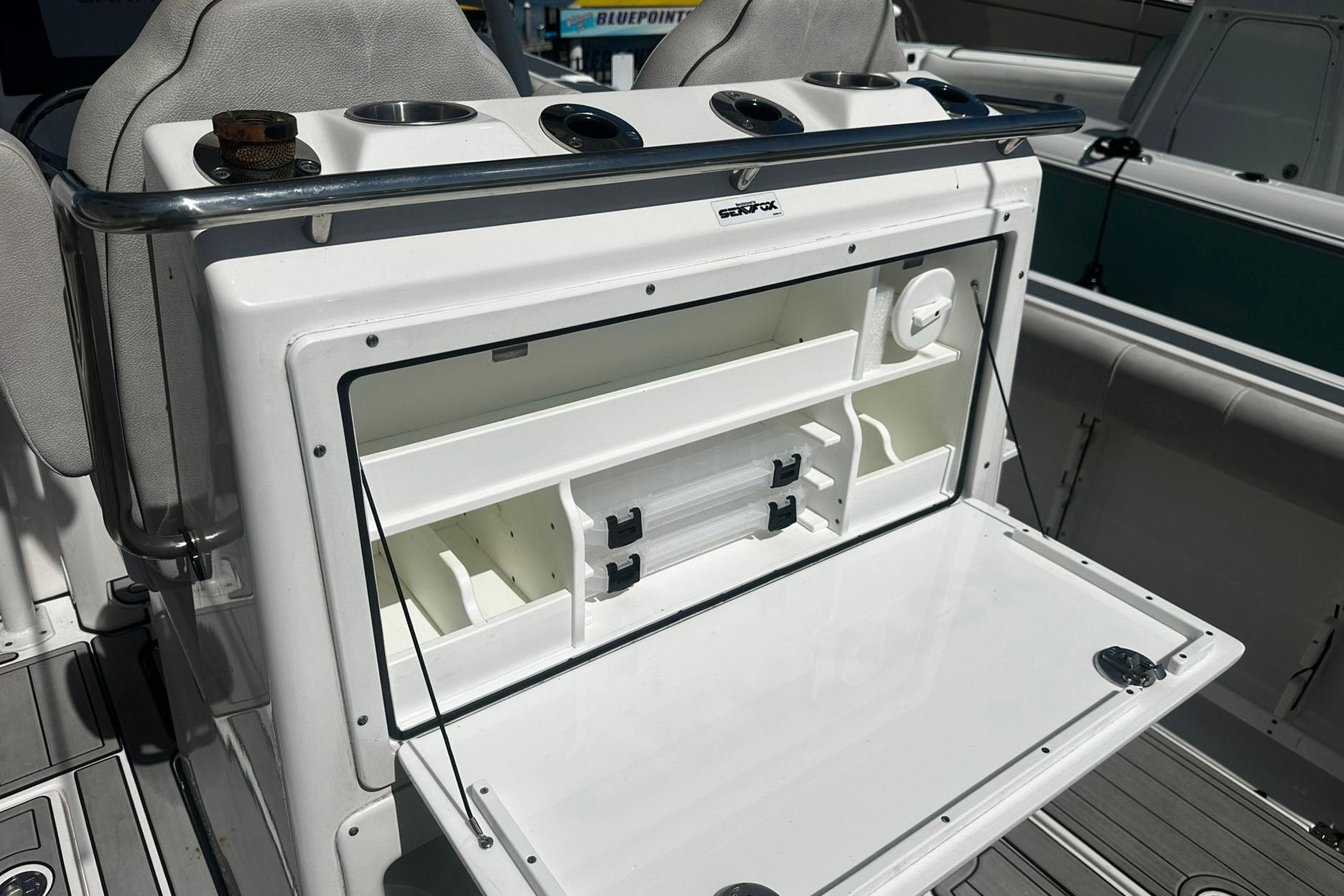 Sea Fox 228 Commander 2002 boat storage compartment with open hatch and organized interior.