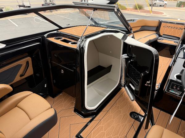 2025 Yamaha Boats 255XD interior with open storage compartment and luxurious seating.