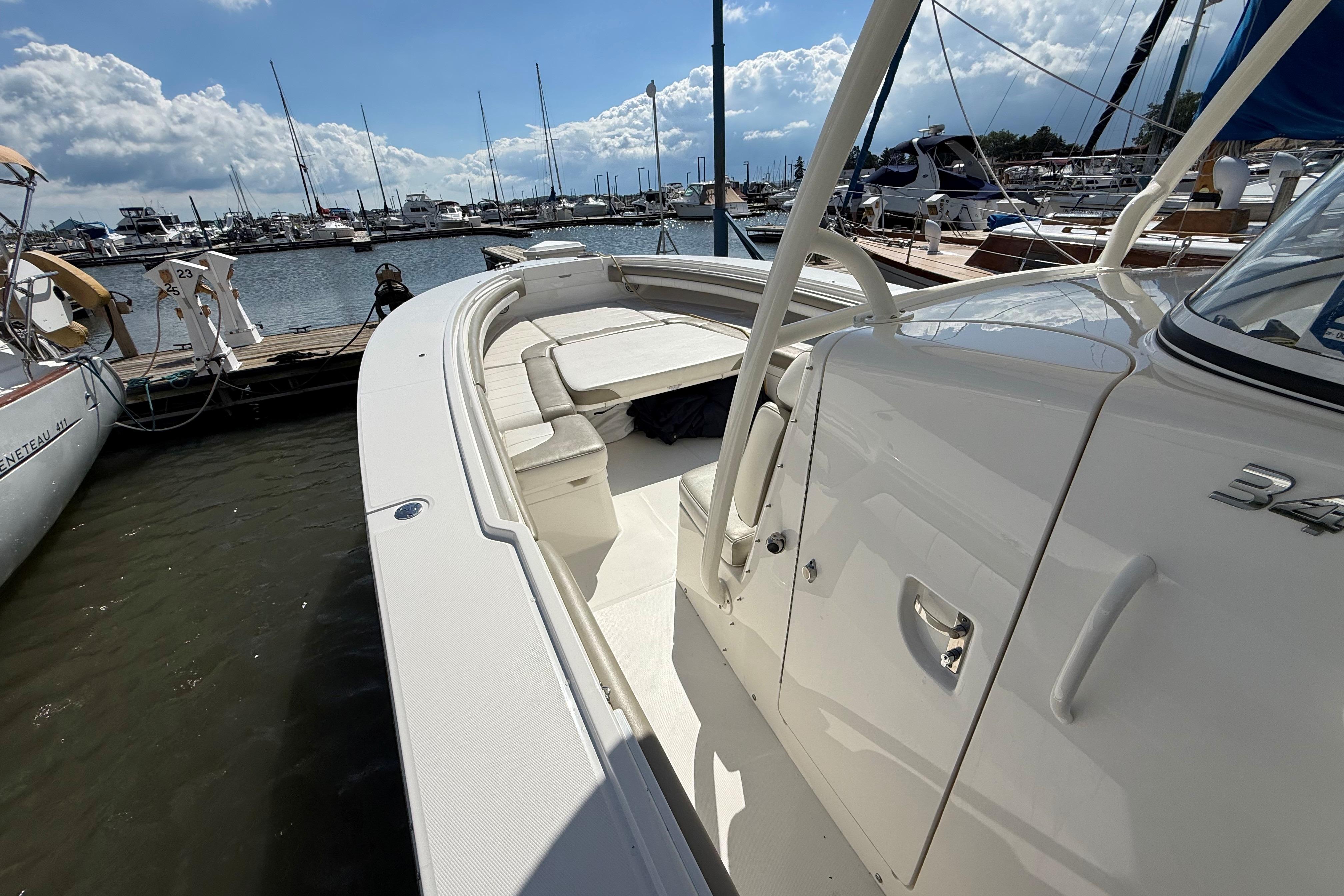 2019 Regulator 34SS boat docked at marina under a partly cloudy sky.