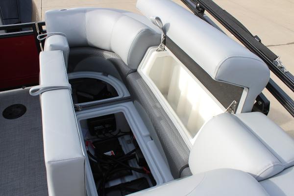 2025 Regency 230 DL3 boat interior with open storage compartments and cushioned seating.