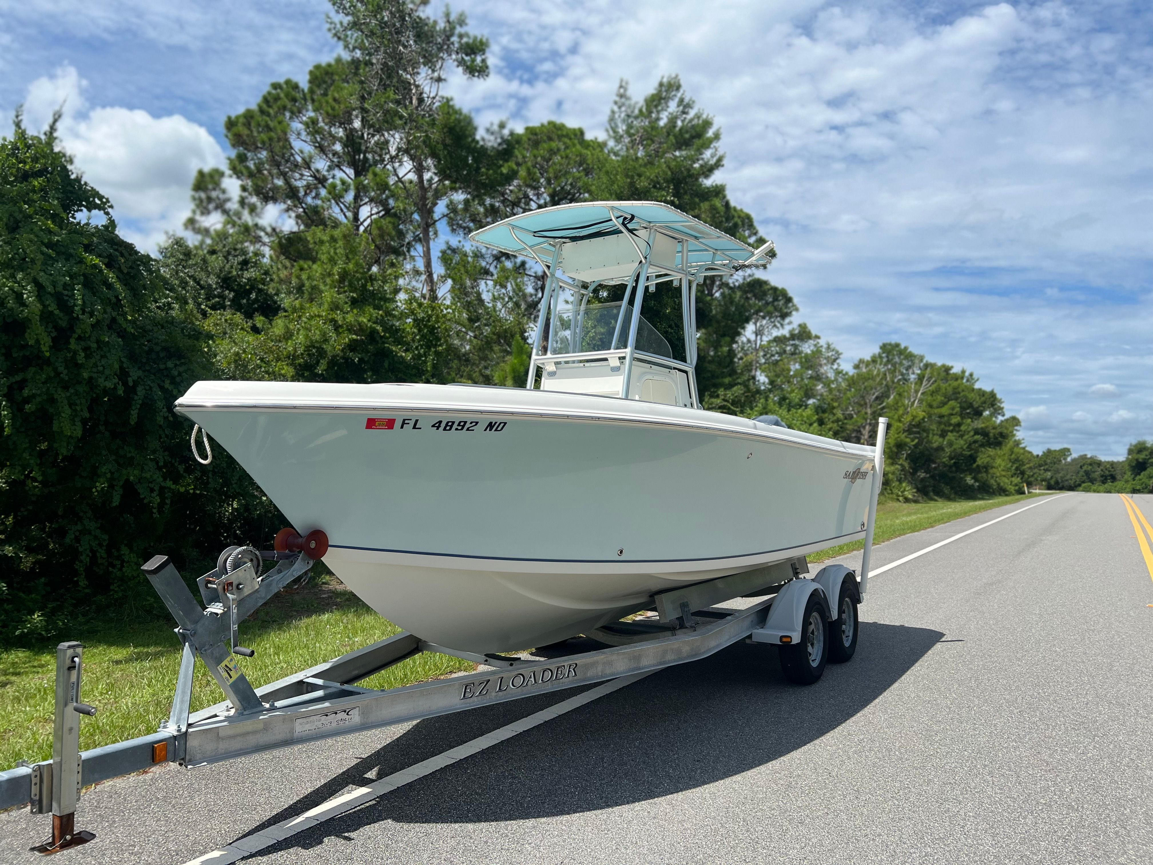 2006 Sailfish 218 CC boat on trailer, road in background.