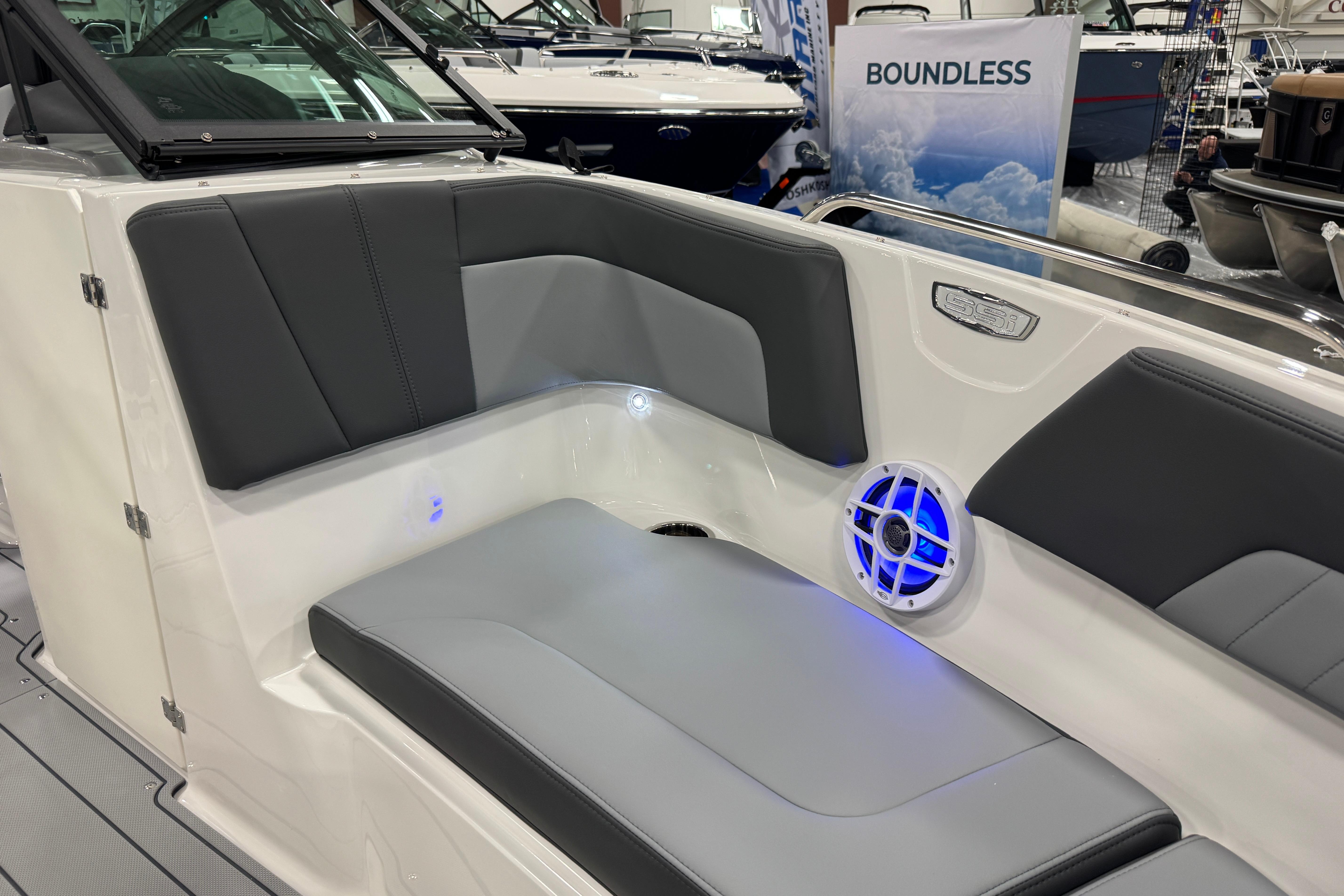 2026 Chaparral 23 SSi boat interior with gray seating and blue LED lighting.
