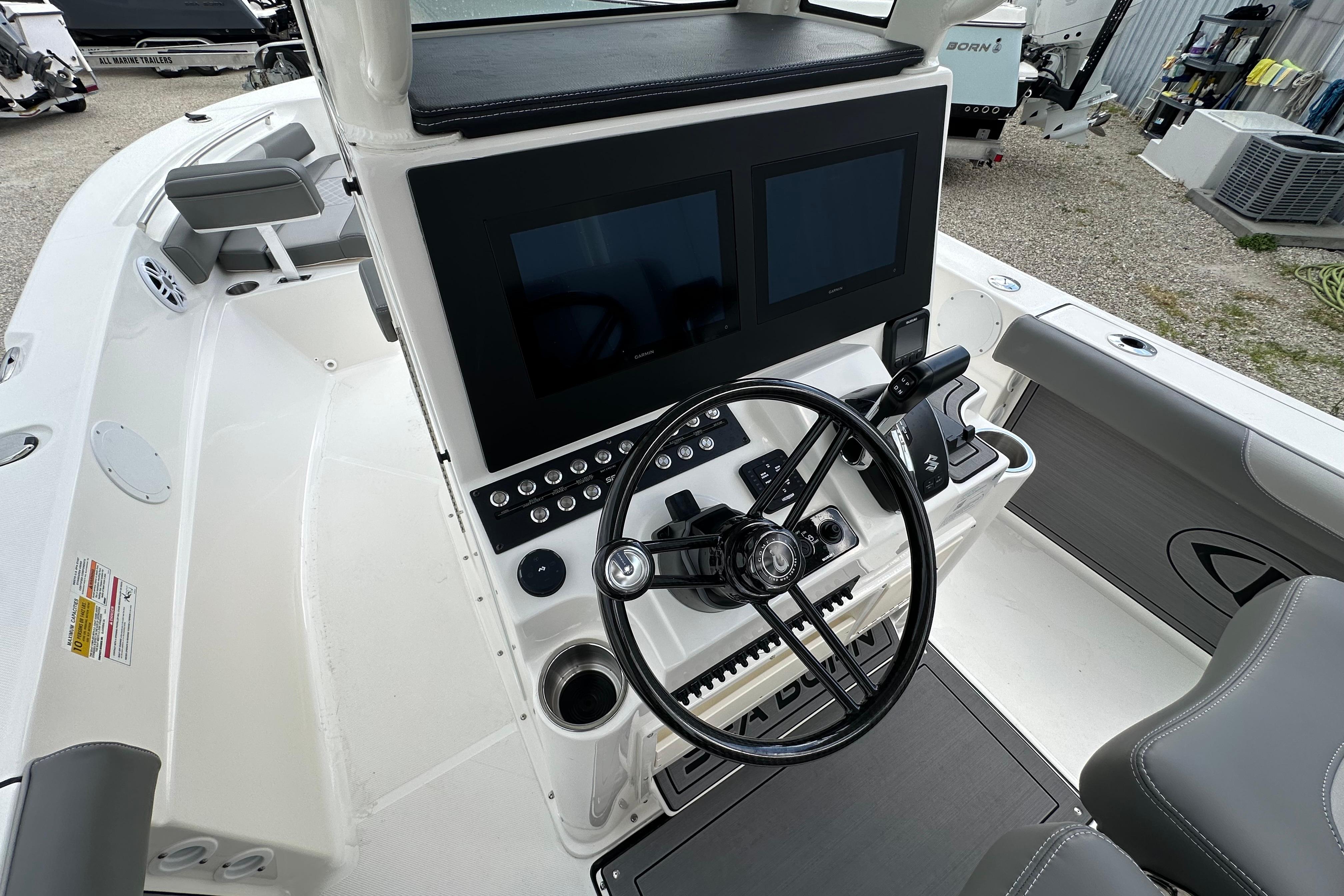 2027 Sea Born LX24 Center Console boat interior with dual screens and steering wheel.