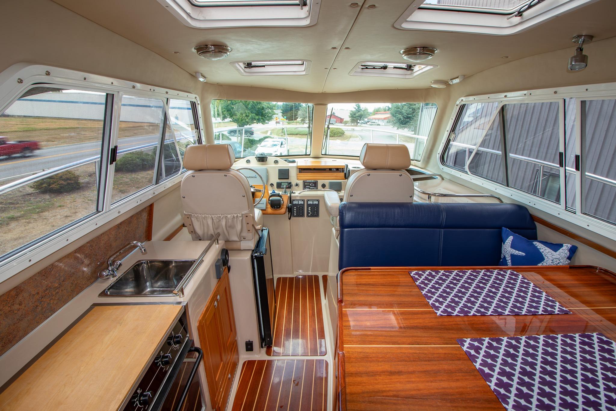 Interior of 2013 Aspen C90 boat with kitchen, seating, and helm.