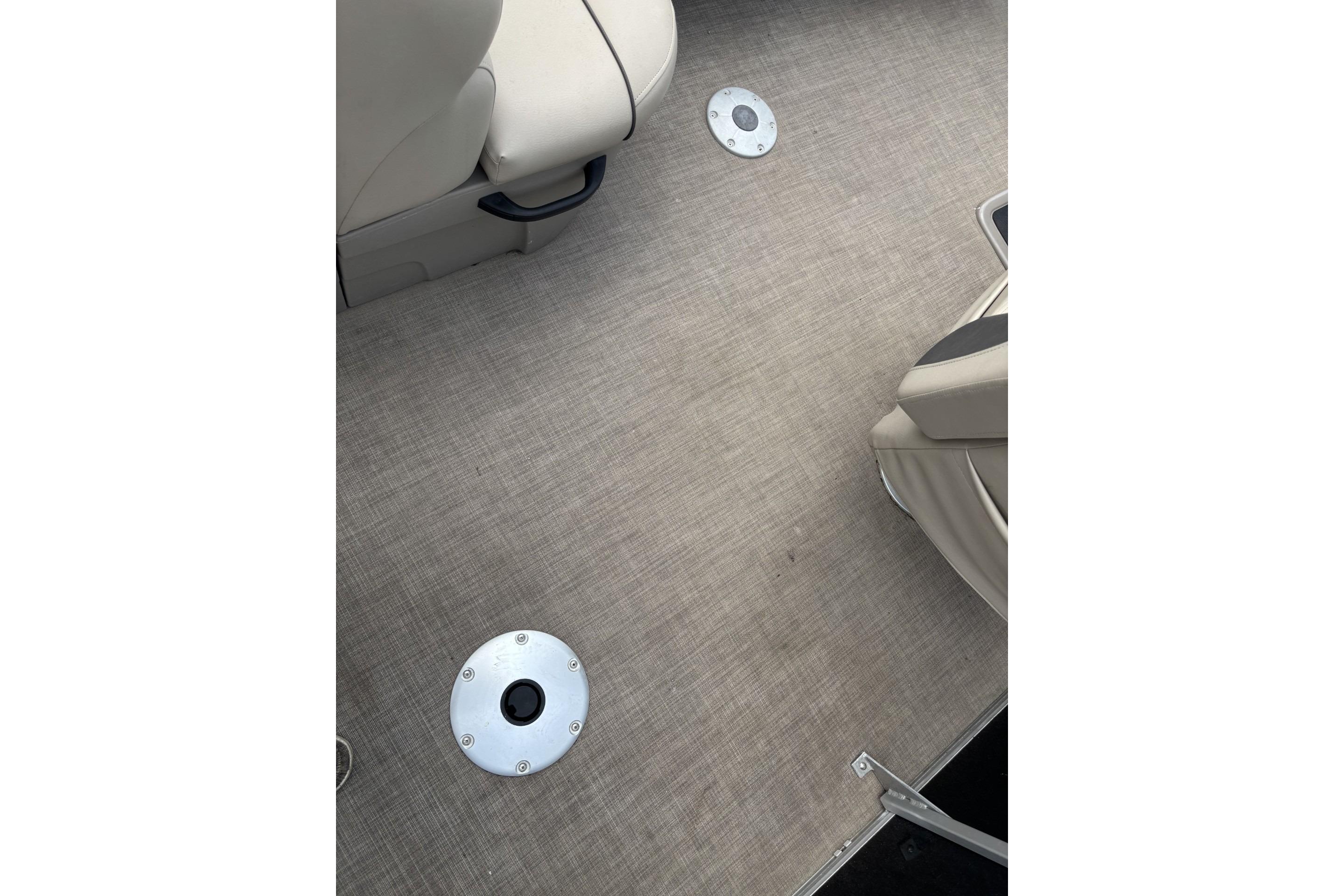Interior view of 2023 Sun Tracker SportFish 20 DLX boat, featuring beige seating and flooring.