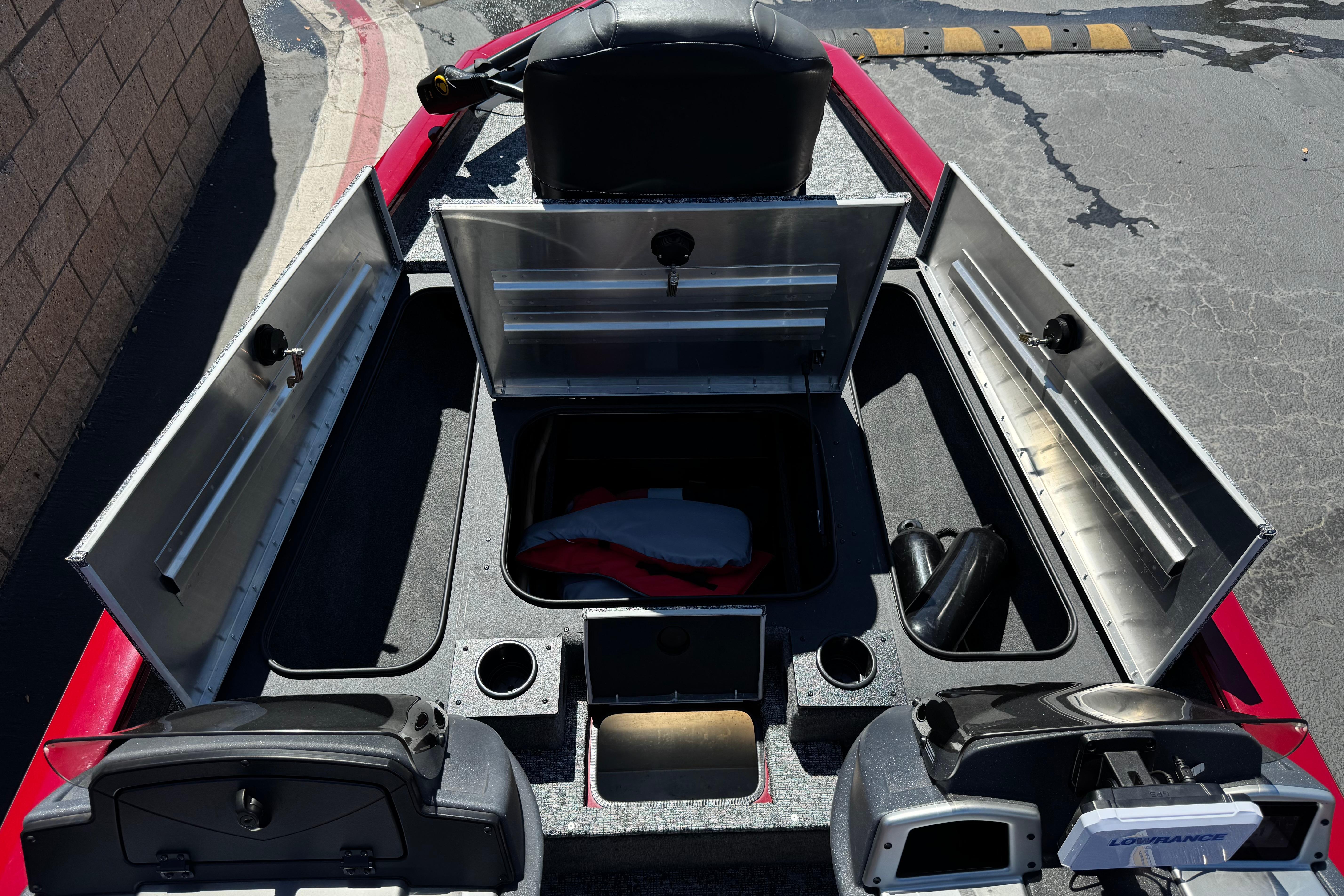 2025 Tracker Pro Team 175 TXW boat interior with open storage compartments and navigation equipment.