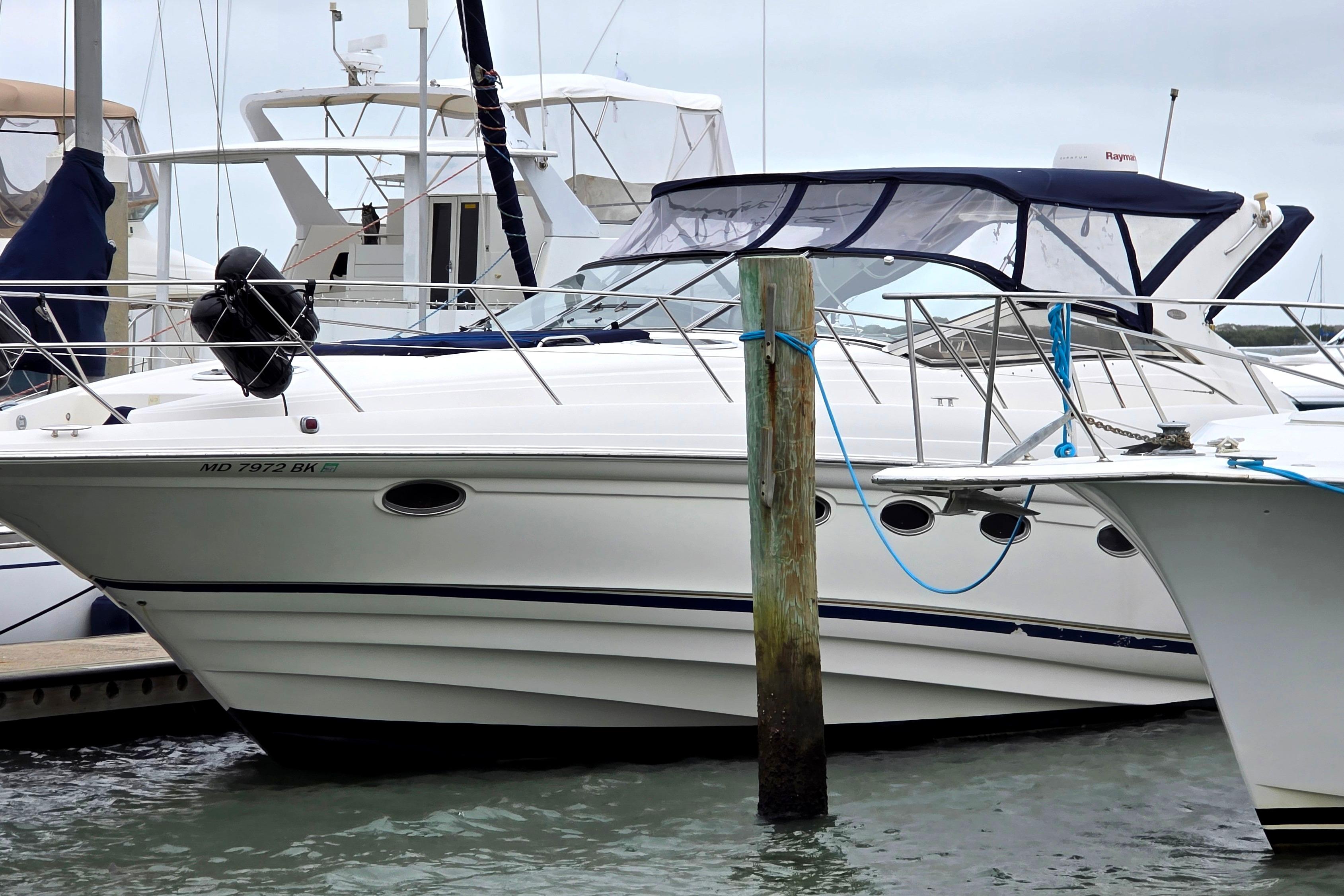 2002 Regal Commodore 4260 yacht docked at marina, featuring sleek design and white exterior.