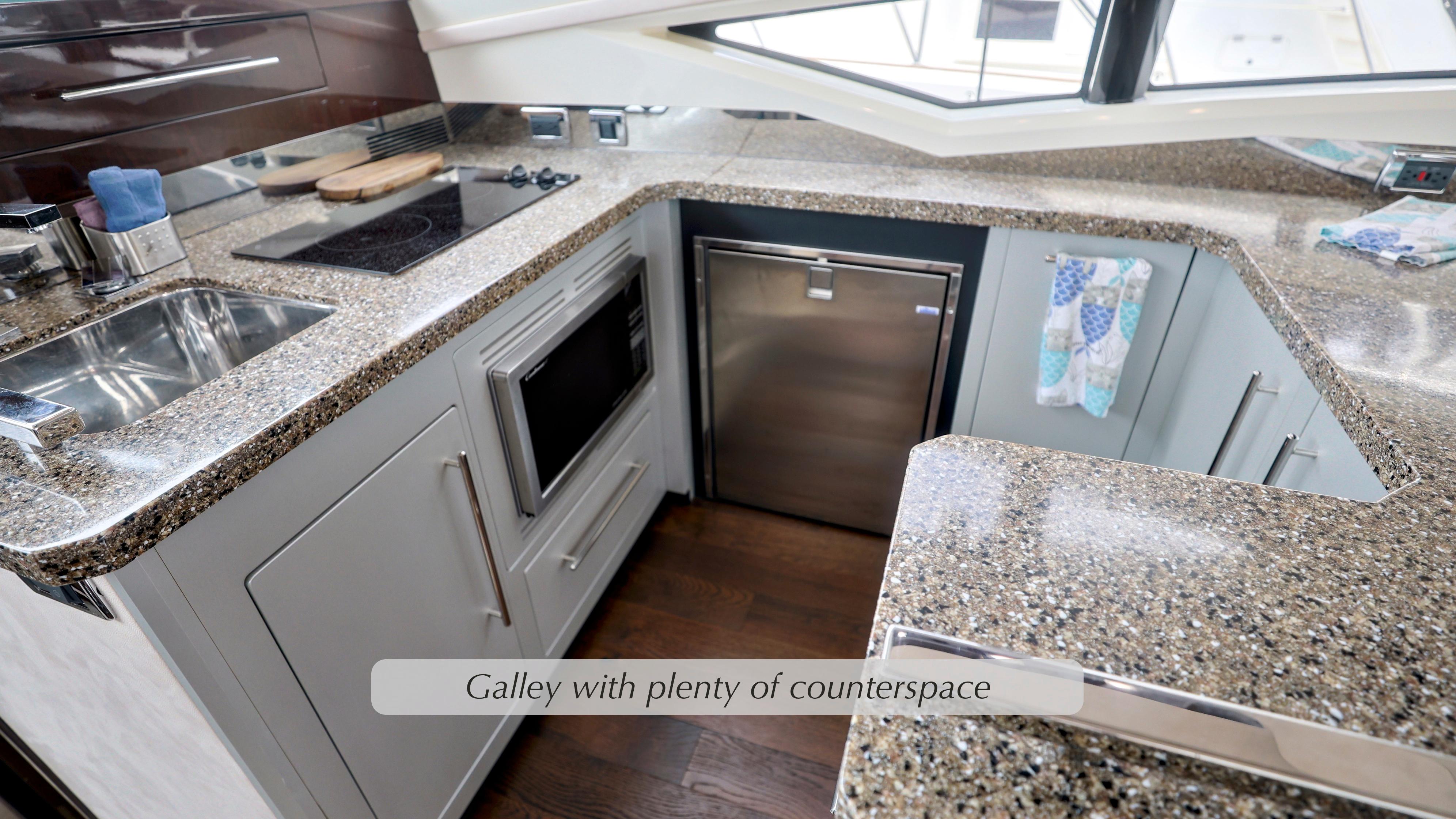 Galley kitchen in 2013 Marquis 500 Sport Bridge with ample counter space and modern appliances.