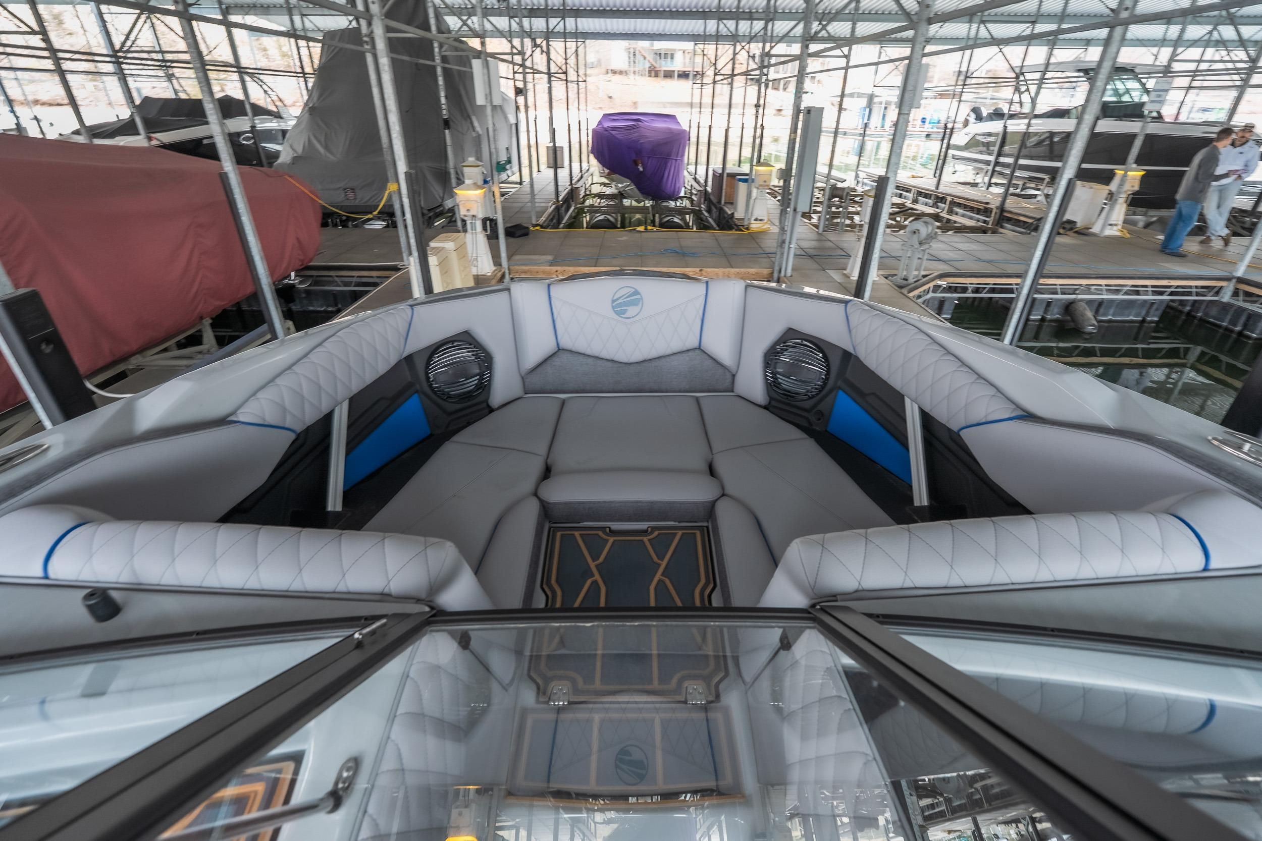 2026 Tigé Z3 boat interior with luxurious seating in a covered marina.