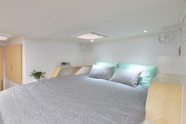 Modern bedroom interior of Seawind 1170 yacht, 2025 model, with cozy bed and soft lighting.