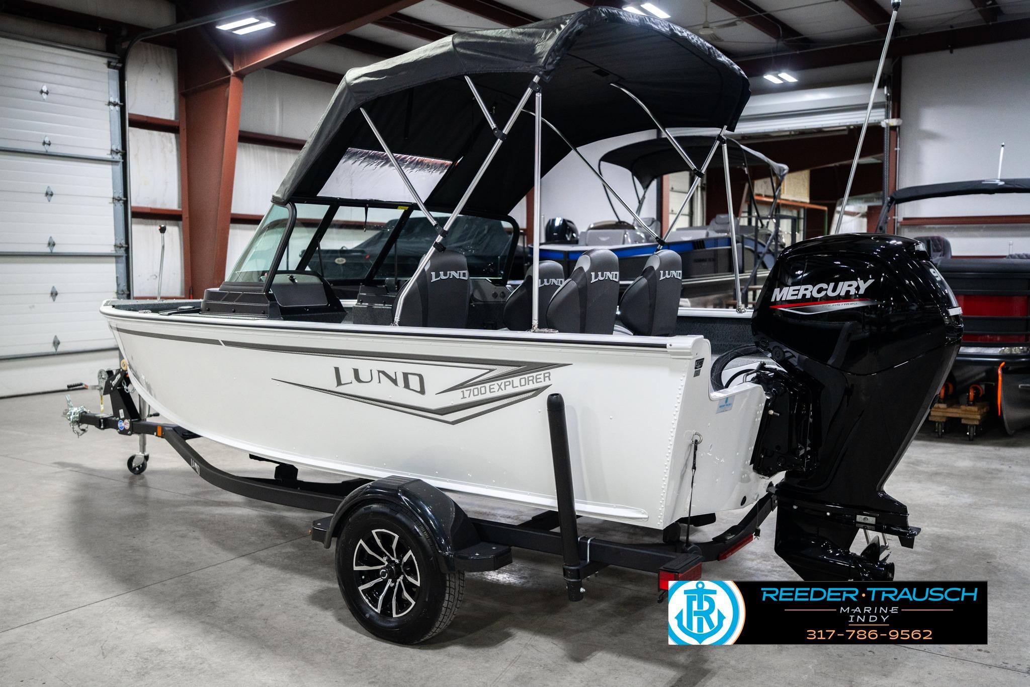 2026 Lund 1700 Explorer Sport boat with Mercury engine in showroom.