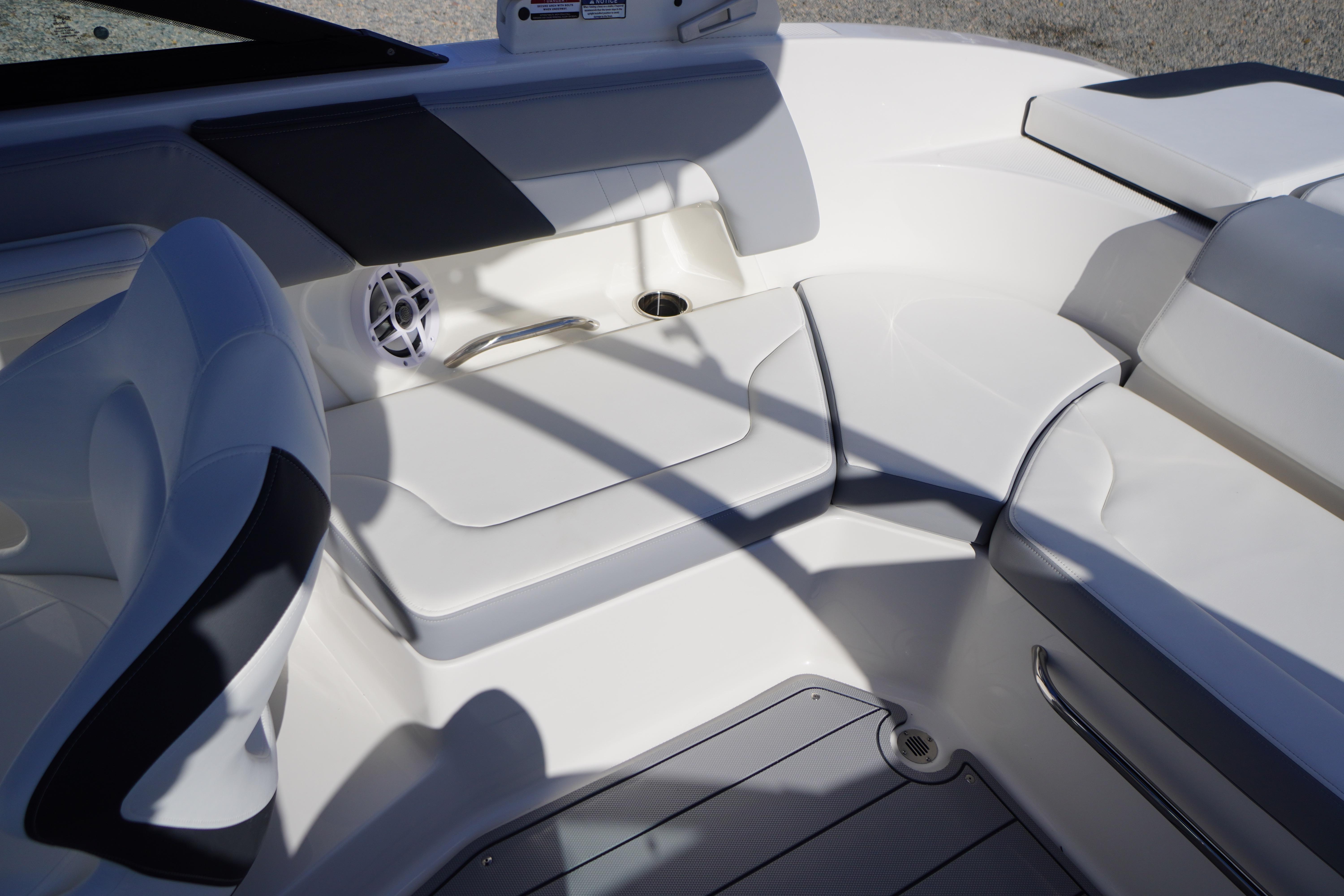 2026 Chaparral 23 SSi OB boat interior with white seating and speaker.