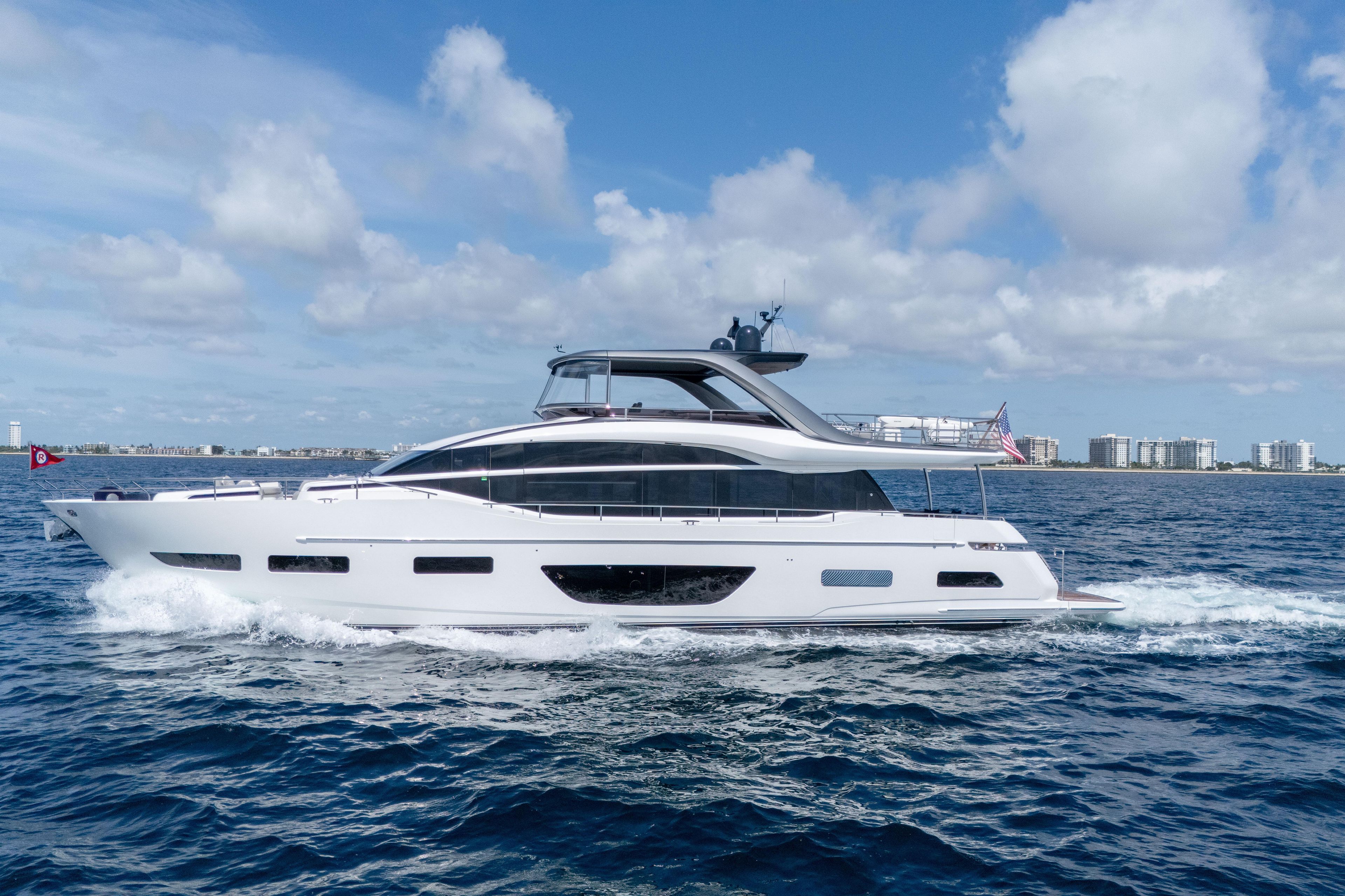 Luxurious 2020 Princess Y85 yacht cruising on open water under a clear blue sky.