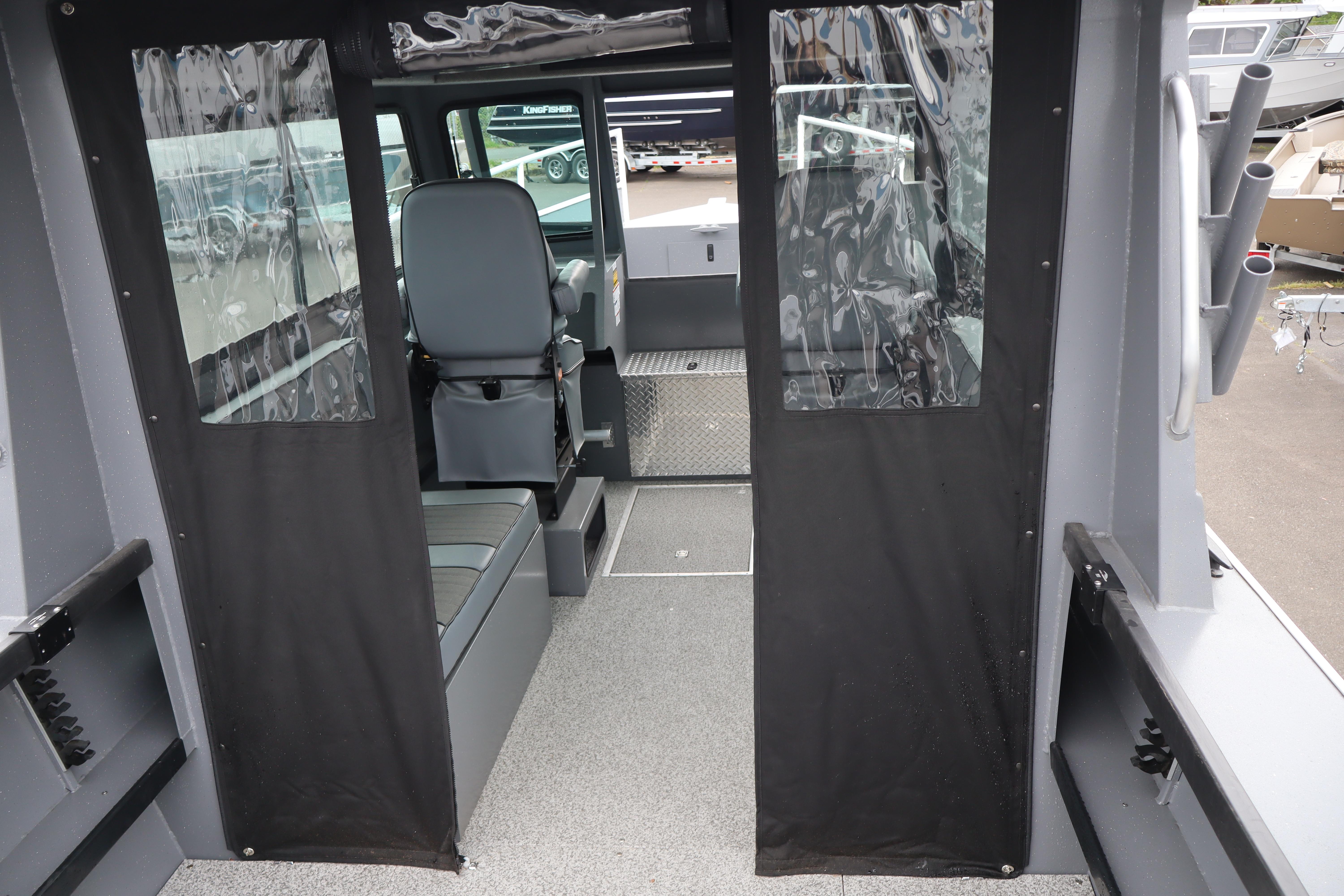 Interior view of 2026 Alumaweld Horizon 24 boat with seating and clear vinyl curtains.