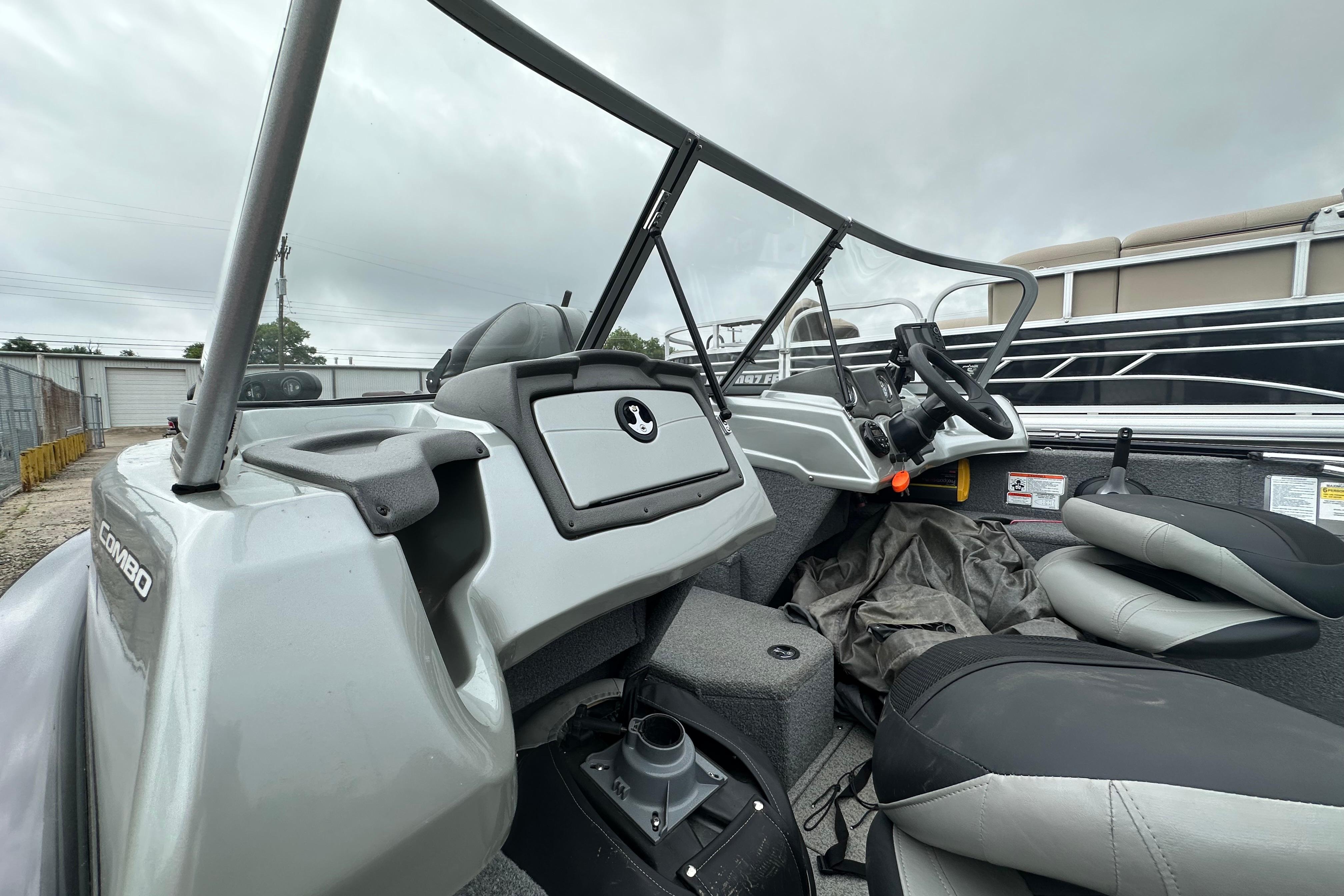 2018 Tracker Pro Guide V-175 Combo boat interior with steering wheel and seating.