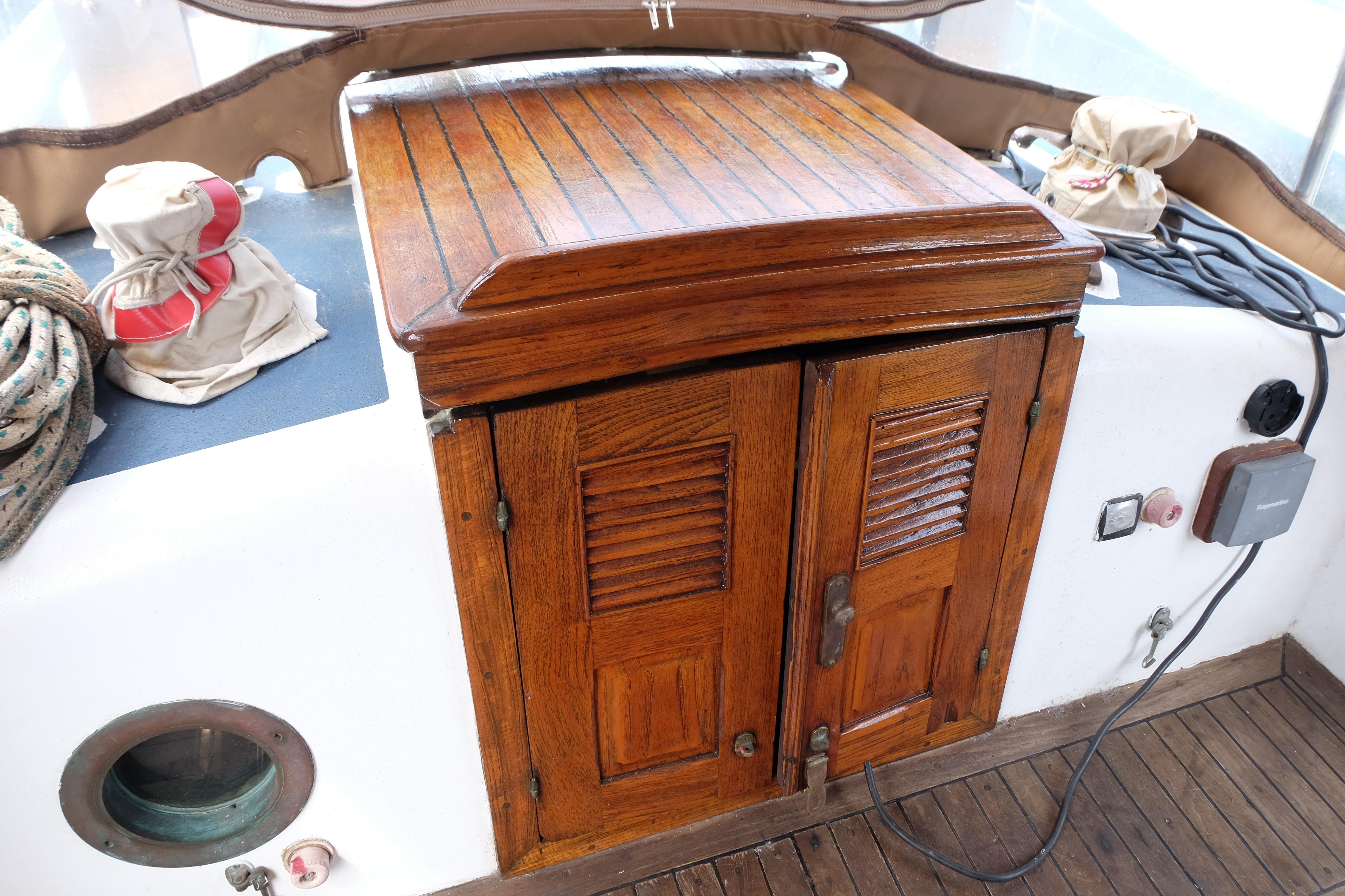 Wooden hatch and deck of 1979 Westwind 35 sailboat, featuring nautical equipment.