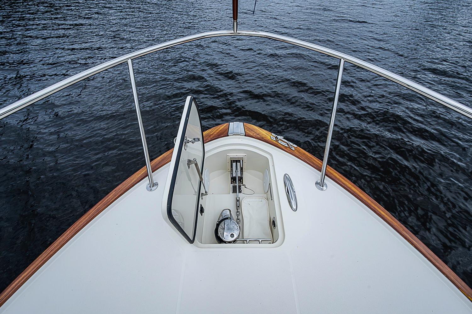 Hinckley Sport Boat 40 X 2023 bow view with open anchor hatch on water.