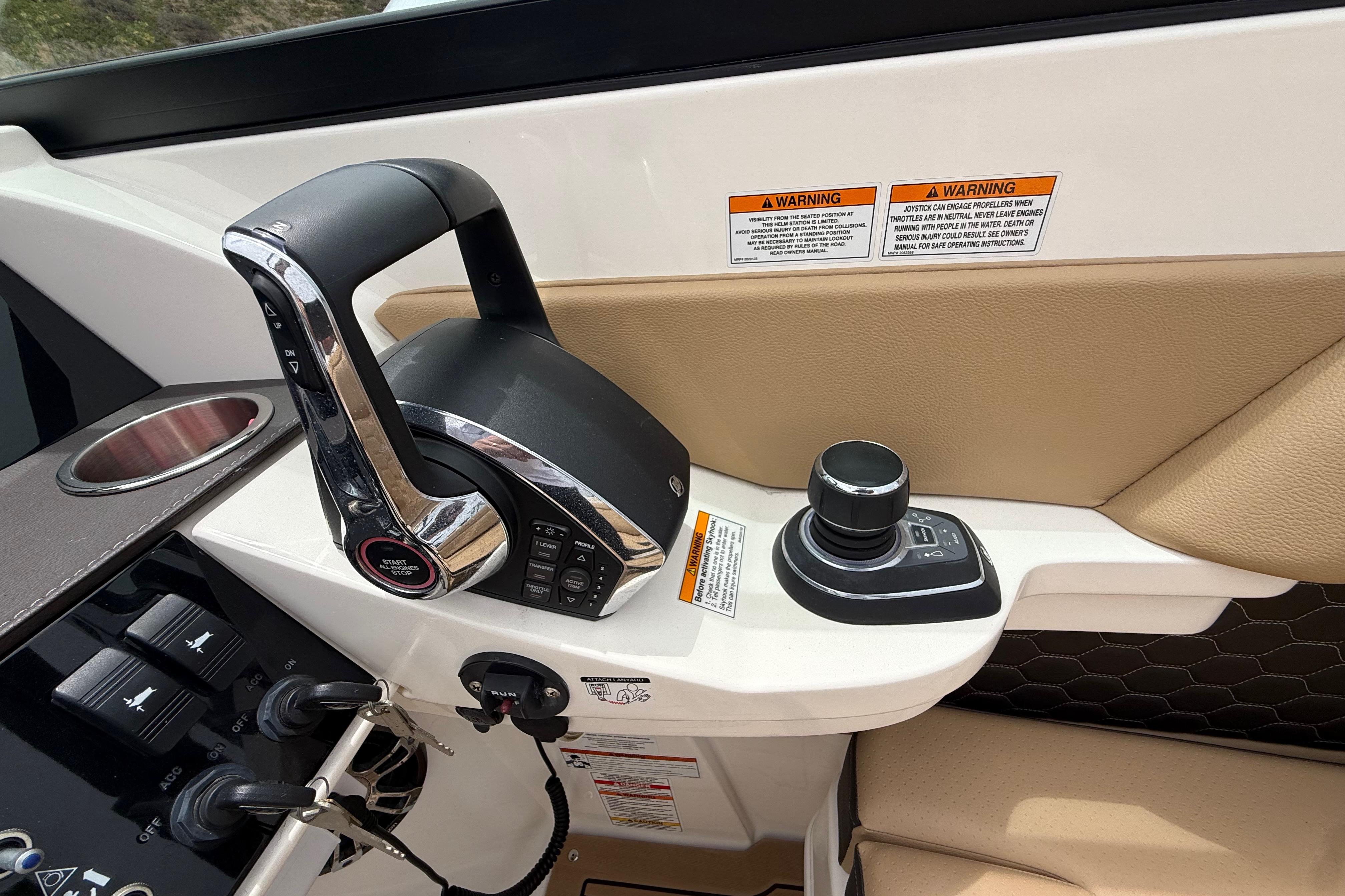 Control panel of 2022 Sea Ray SDX 290 Outboard with joystick and throttle.