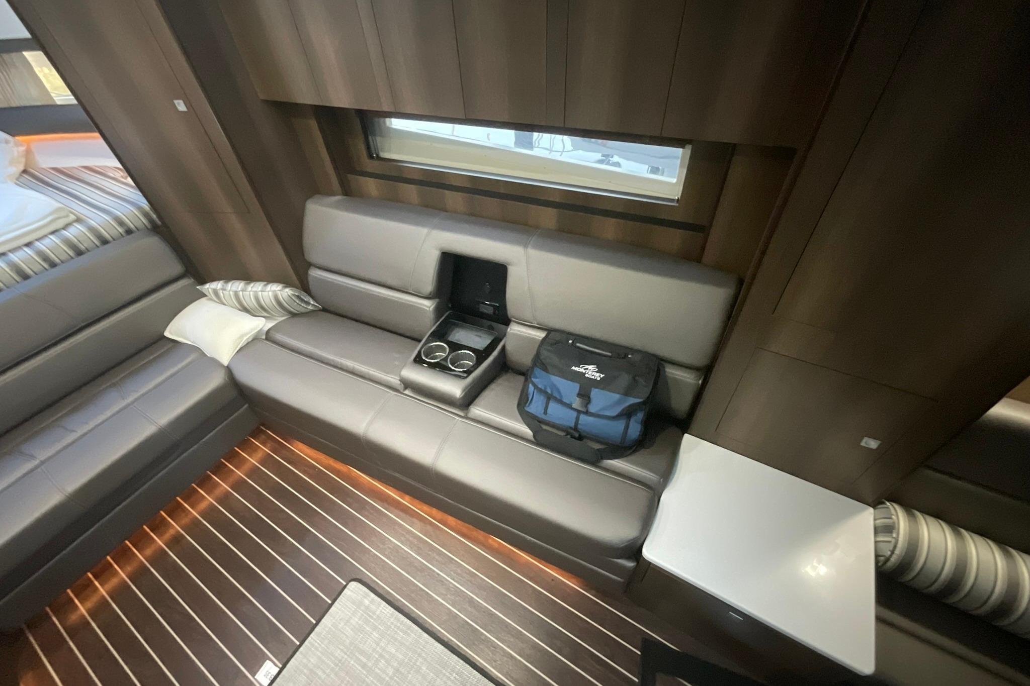 Luxurious interior of 2019 Monterey 335 Sport Yacht with leather seating and wooden flooring.