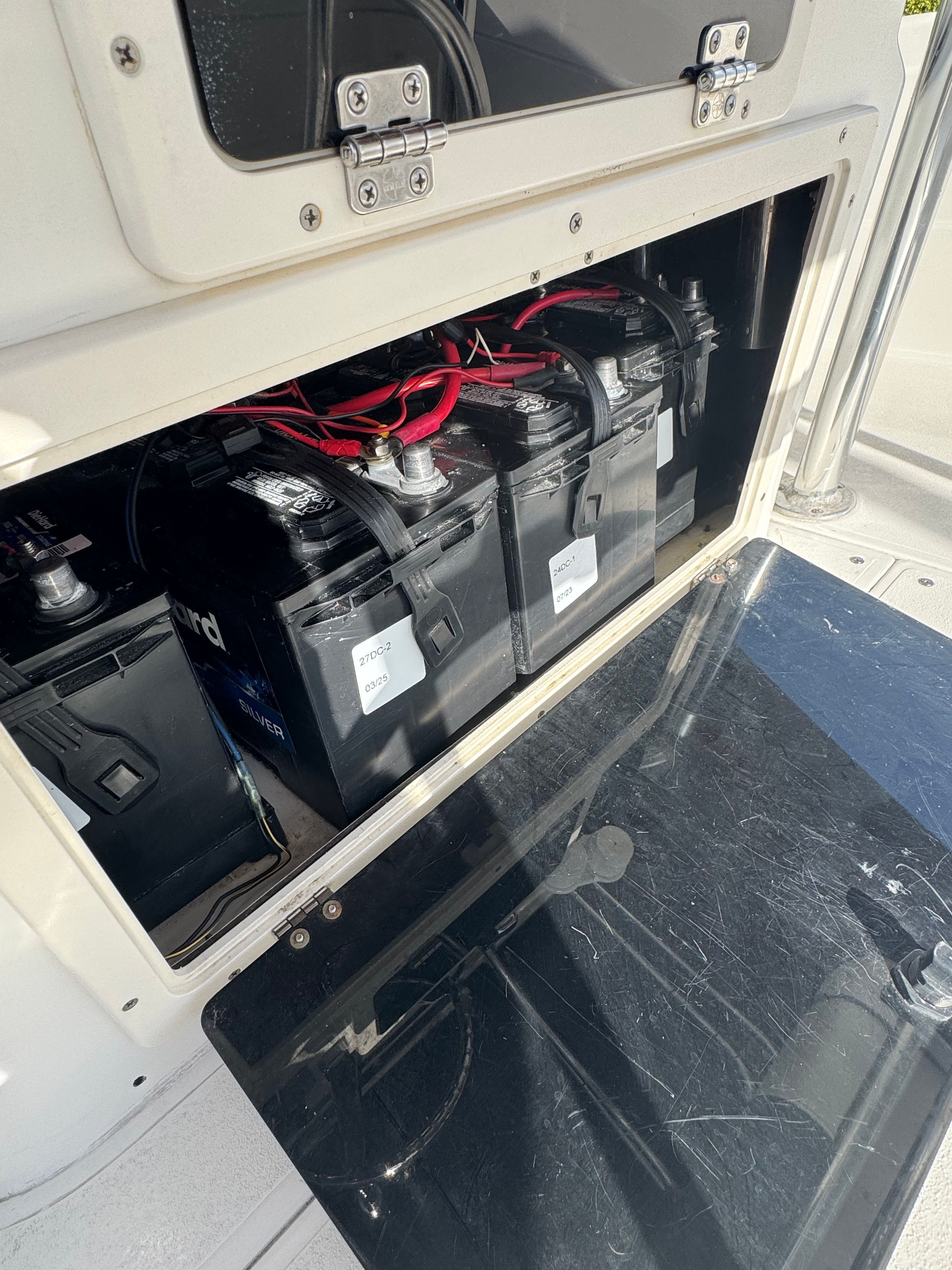 Battery compartment of a 2004 ShearWater LTZ boat with multiple batteries.