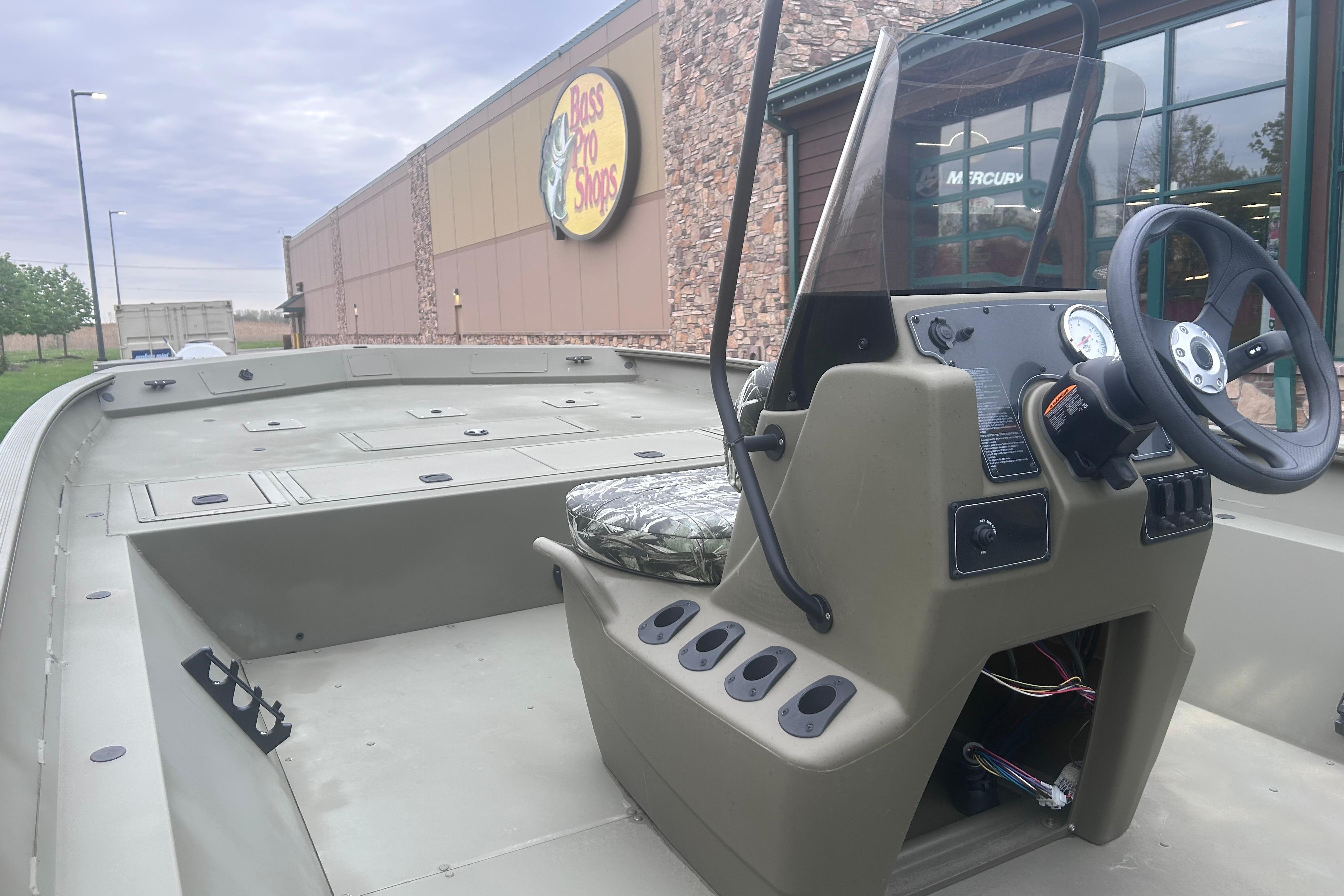 2024 Tracker Grizzly 2072 CC boat at Bass Pro Shops, featuring a spacious deck and console.