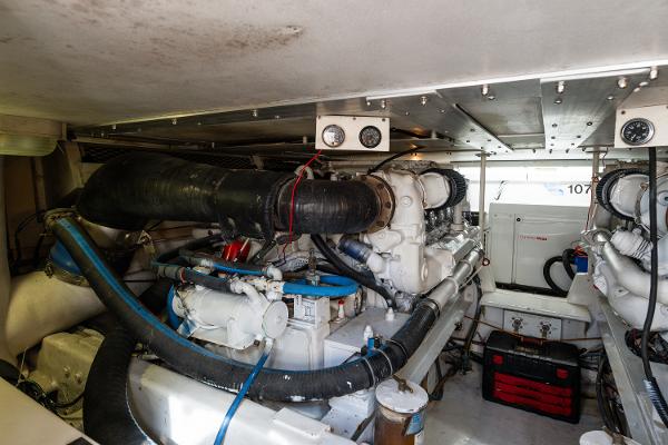 Engine room of a 1999 Viking 47 Convertible yacht, showcasing machinery and equipment.
