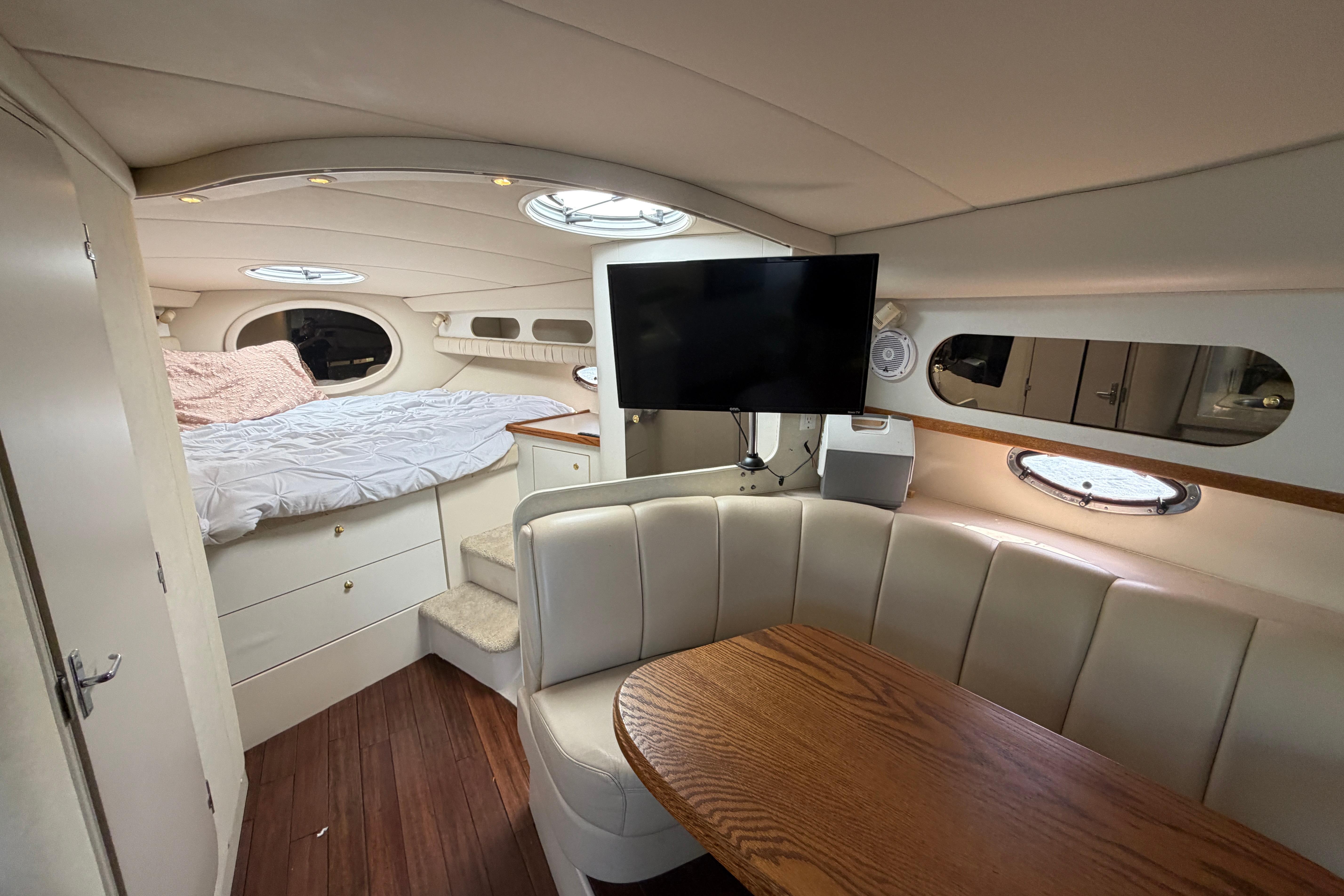 Interior of a 1997 Cruisers 3575 yacht with cozy seating and a bed.