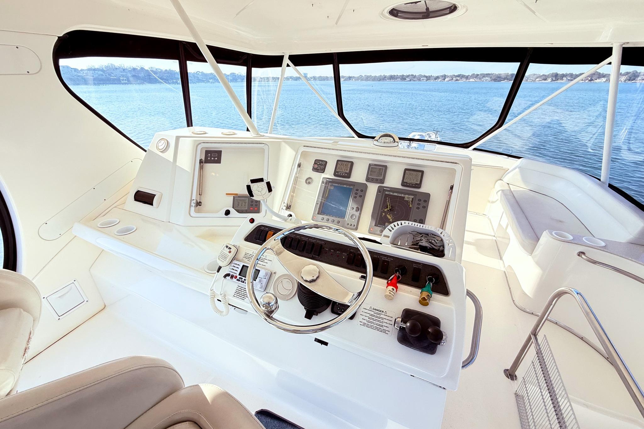 2004 Silverton 48 Convertible yacht helm with navigation instruments and panoramic water view.