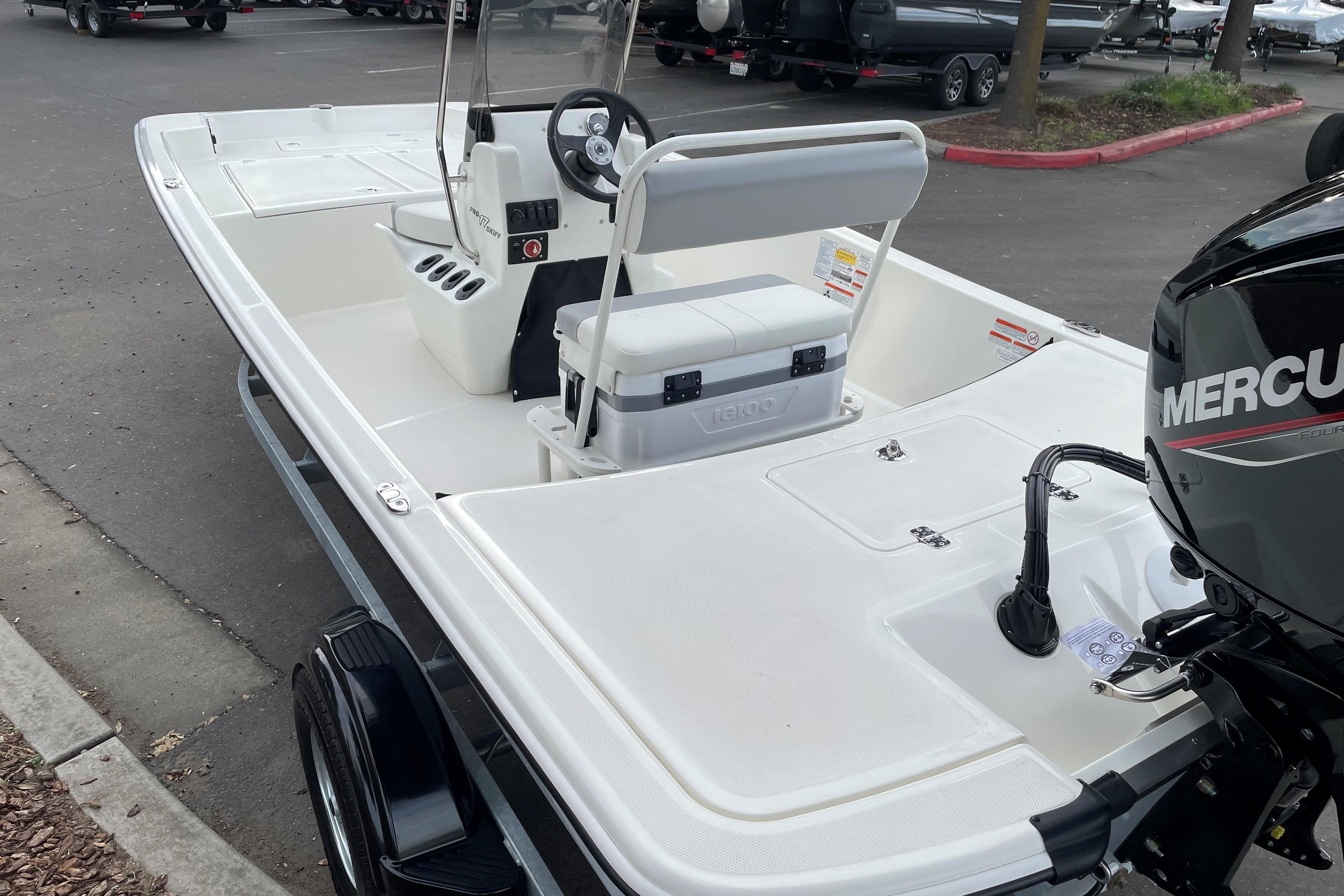 2025 Mako Pro Skiff 17 CC boat with Mercury engine, parked on a trailer.