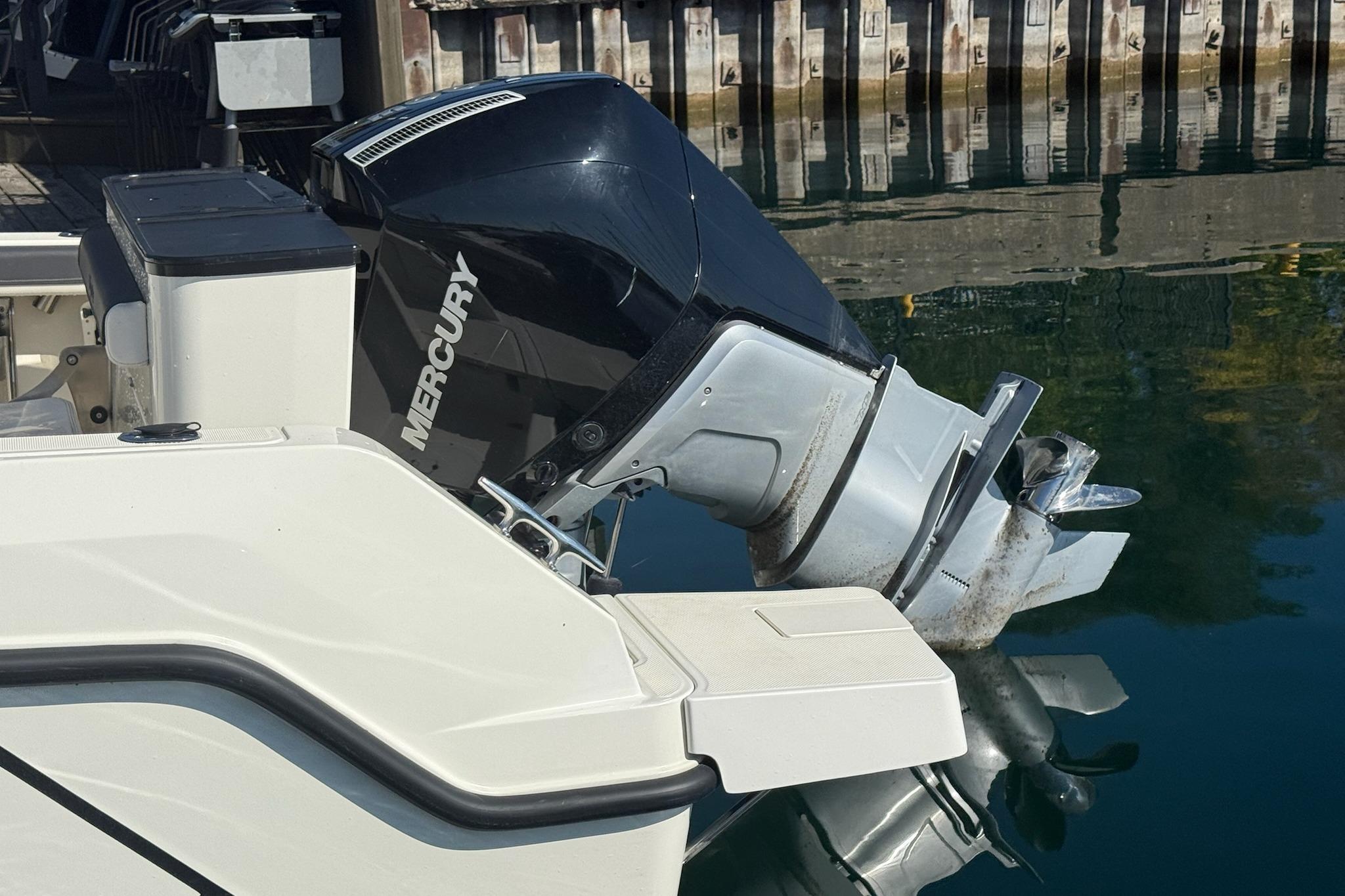 2024 Bayliner Trophy T25 Pilothouse with Mercury outboard engine at dockside.